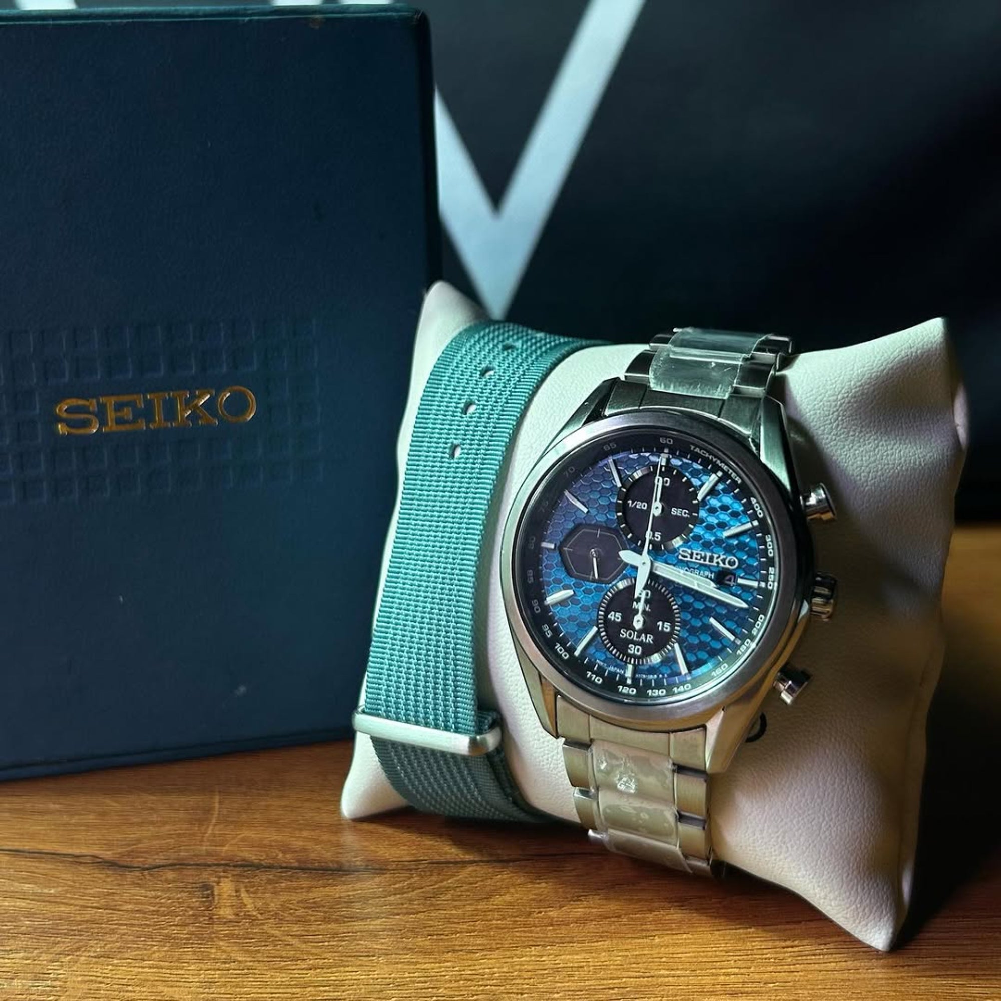 Seiko Essentials 41.4mm Solar Chronograph watch with a Blue dial and steel bracelet on a display pillow