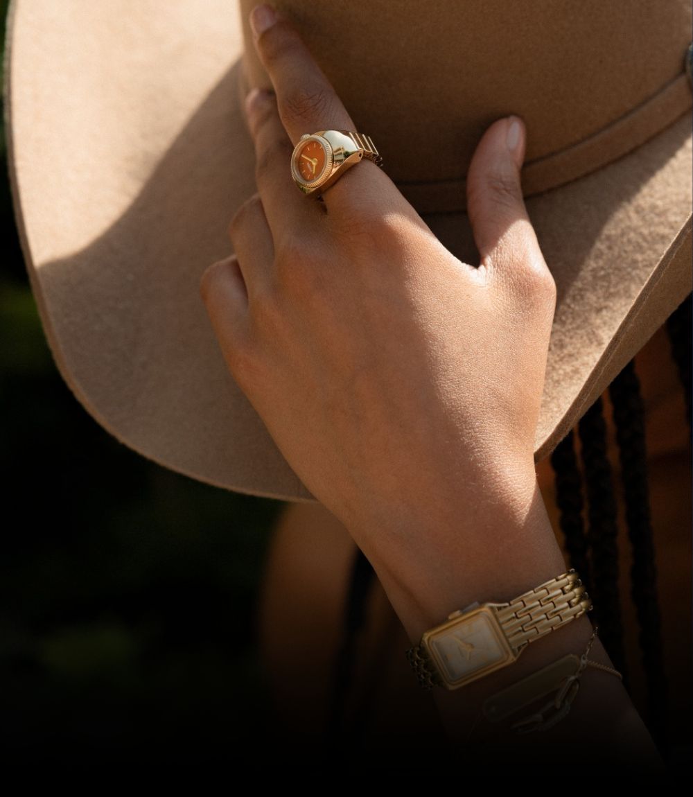 Fossil rectangular mens watch and Fossil watch ring displayed with gold-tone link bracelet, cream dial, and Roman numerals