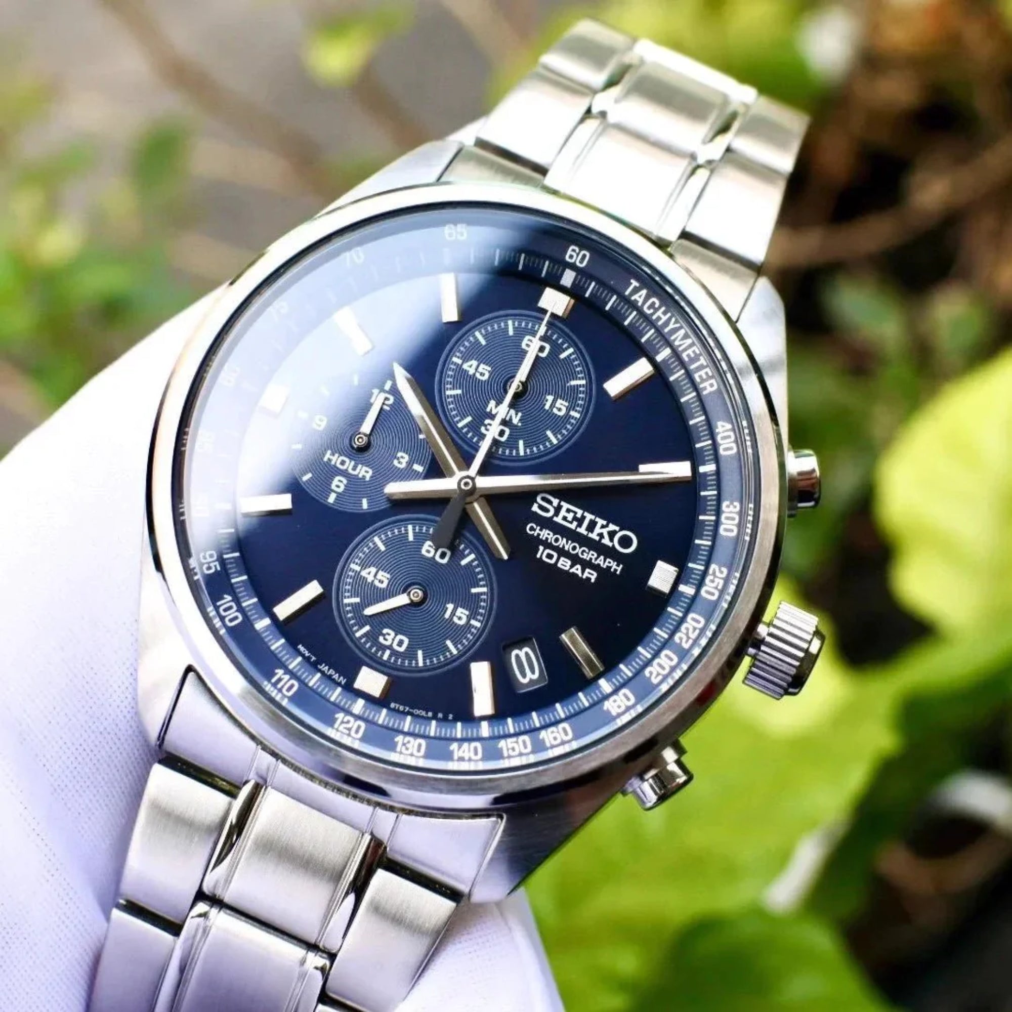Seiko SSB377P1 41.5mm blue dial chronograph watch held by gloved hand