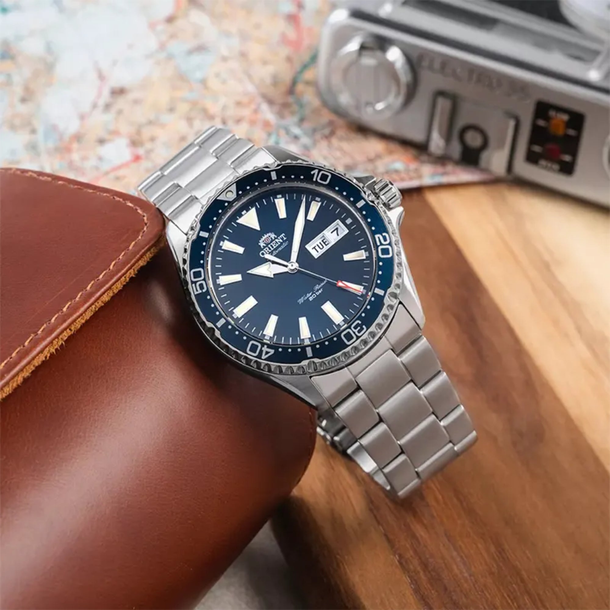 Orient Mako Blue dial automatic dive watch resting on a brown leather pouch