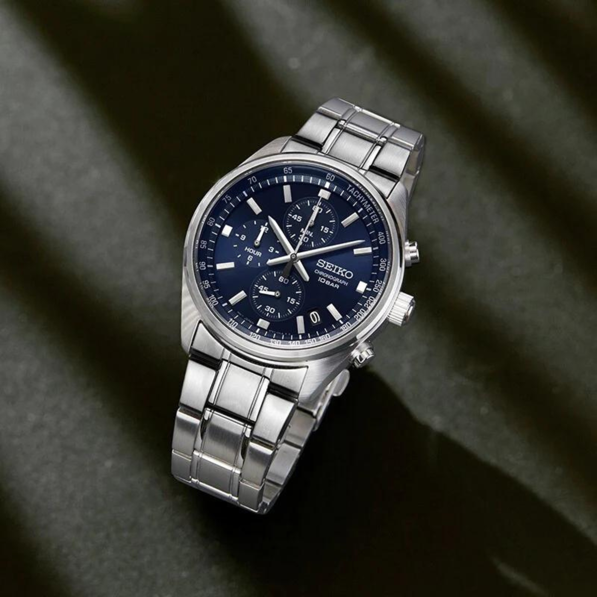 Seiko Essentials SSB377P1 Chronograph Blue Dial displayed at an angle on textured surface