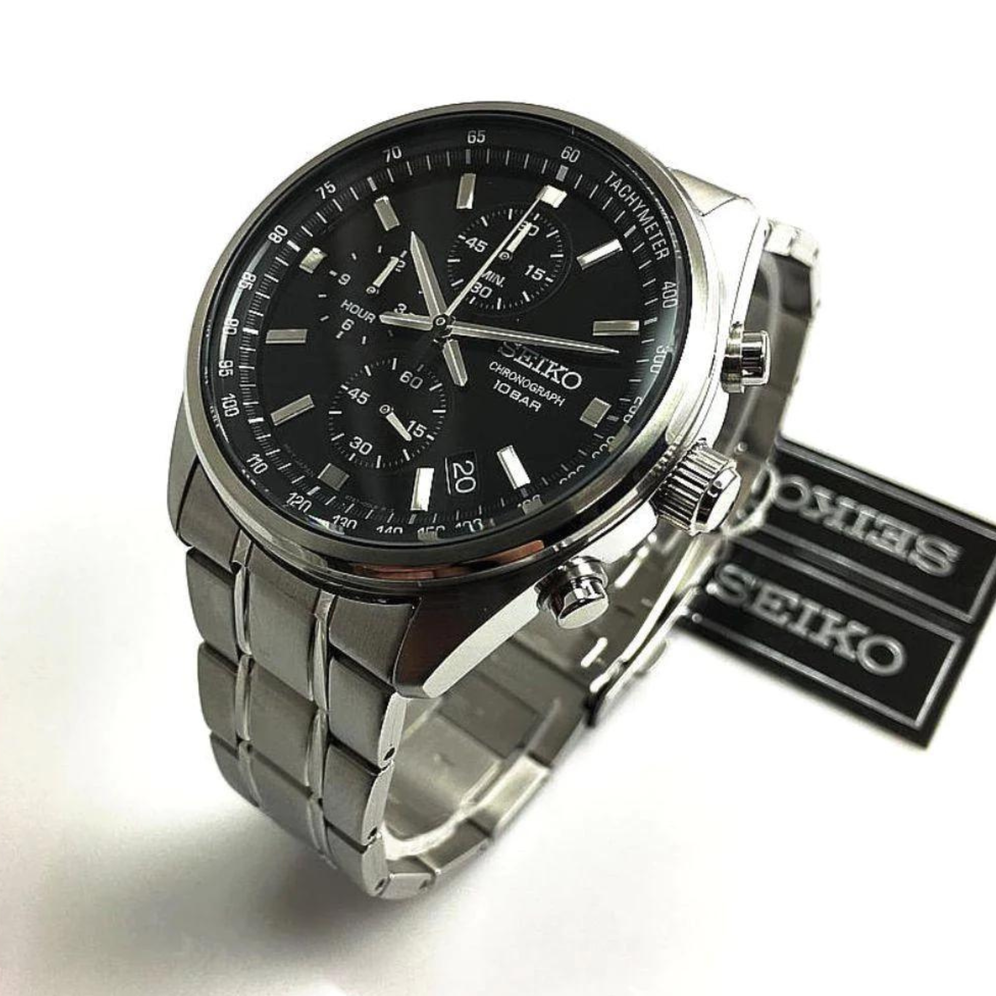 Seiko watch with black dial and silver metal strap on a white background