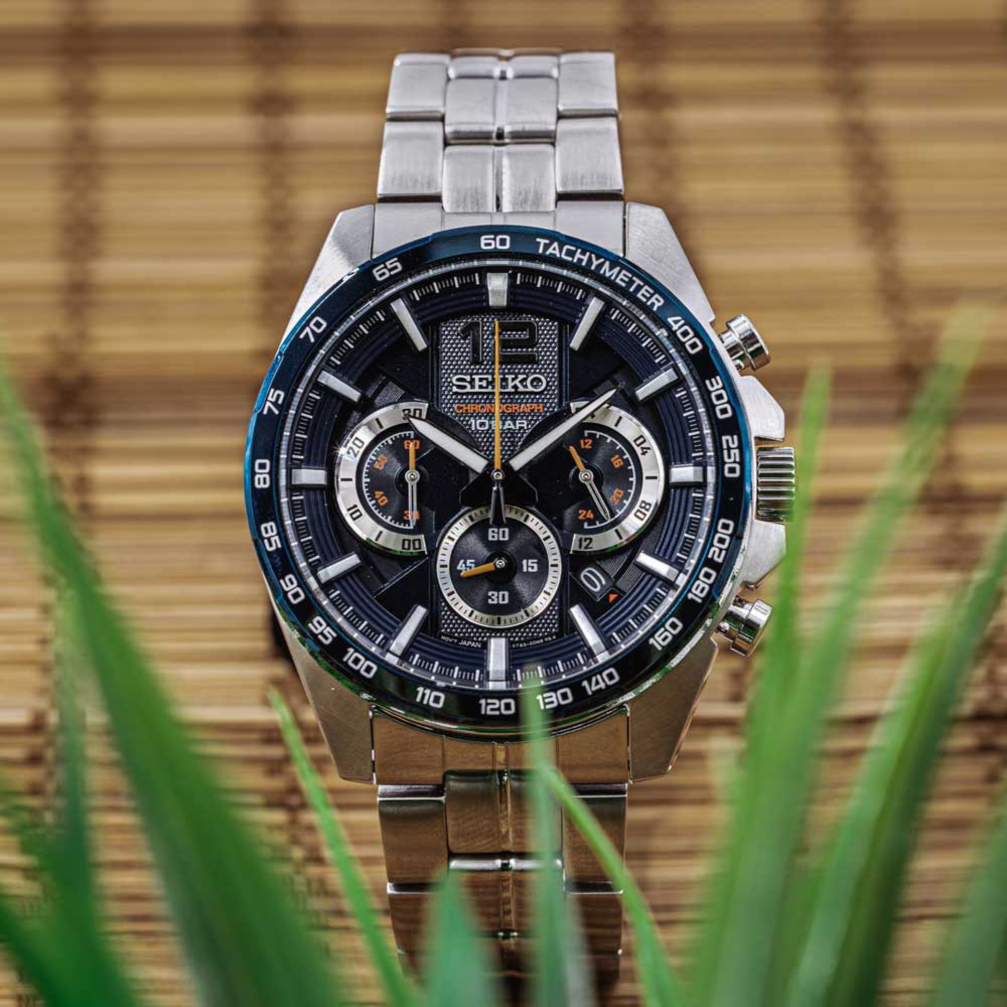 Seiko SSB345P1 blue dial chronograph watch displayed on bamboo mat with green leaves