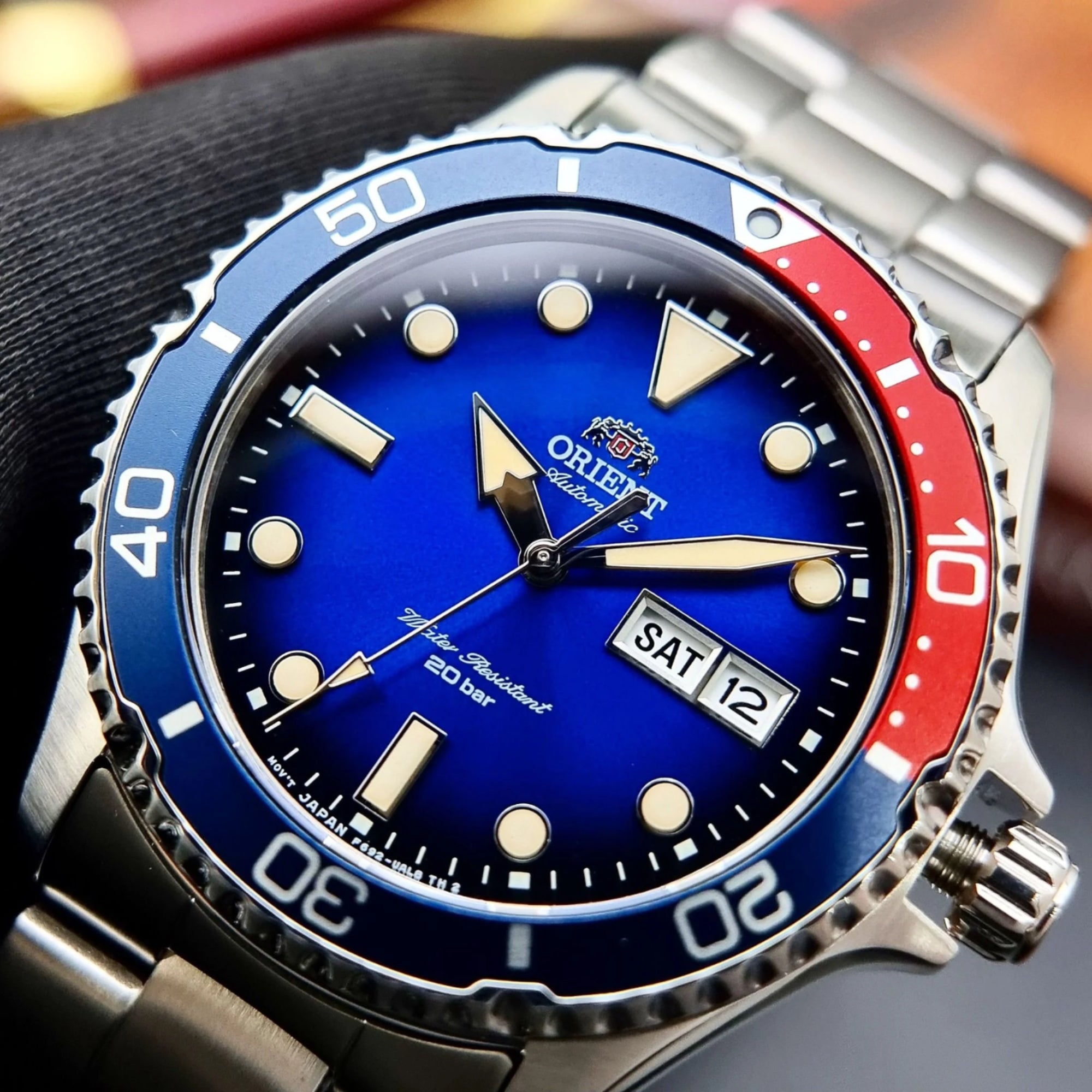 Close-up of a blue and red wristwatch with silver accents