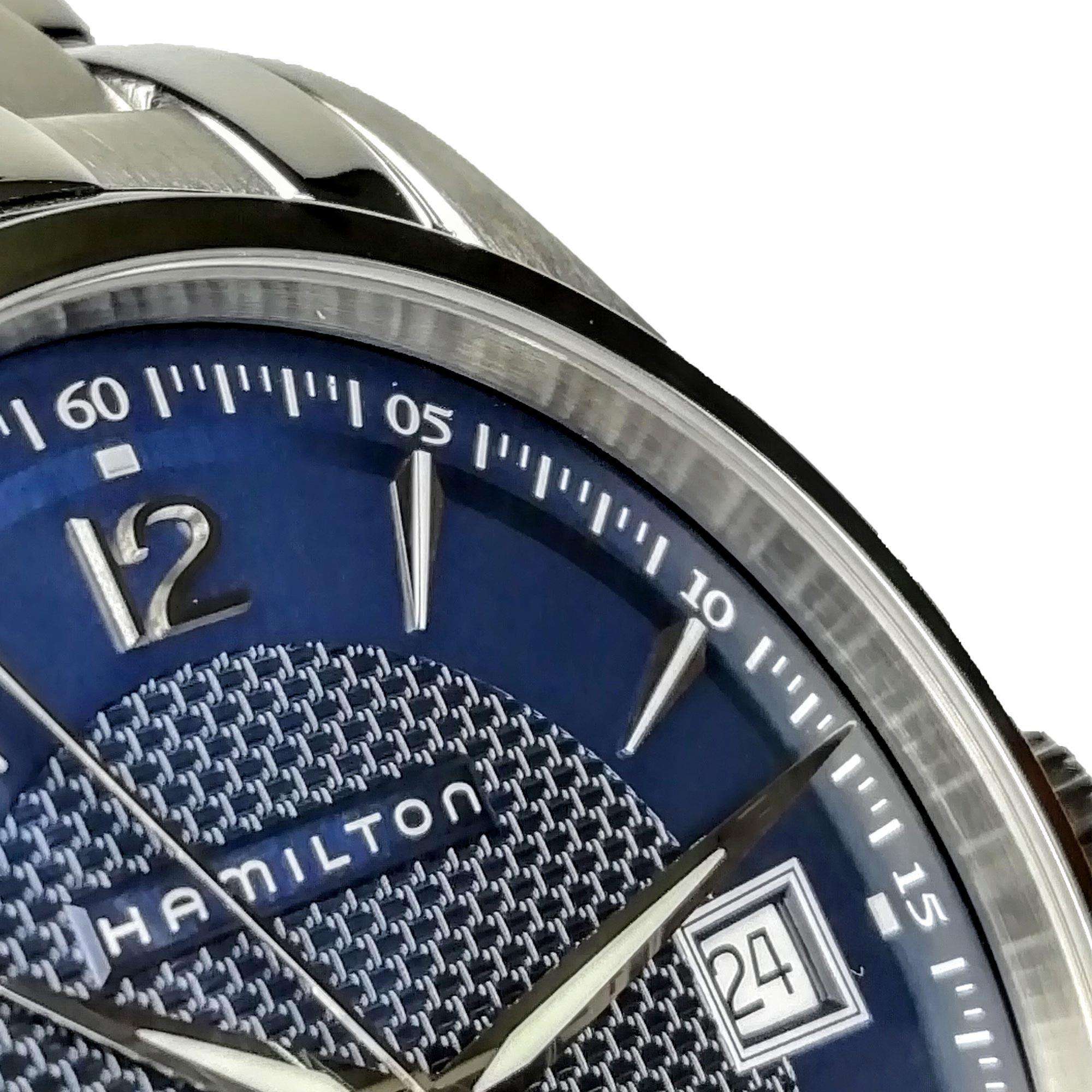Close-up of a Hamilton watch face with blue dial and silver accents.