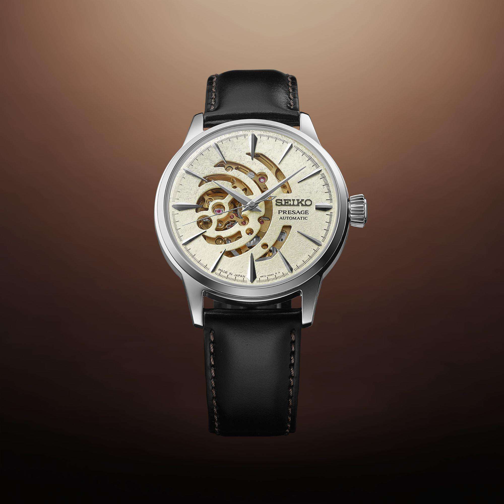 Seiko watch with black leather strap on a brown gradient background