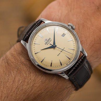 Orient RA-AC0M04Y10B-EX cream dial leather watch on a persons wrist view