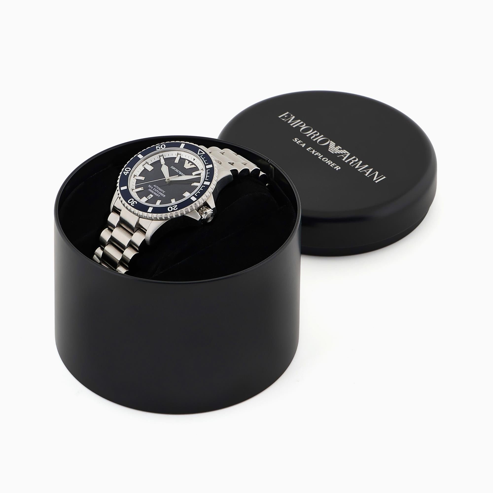 Watch in a black box with 'Exposure Armani' branding on a white background
