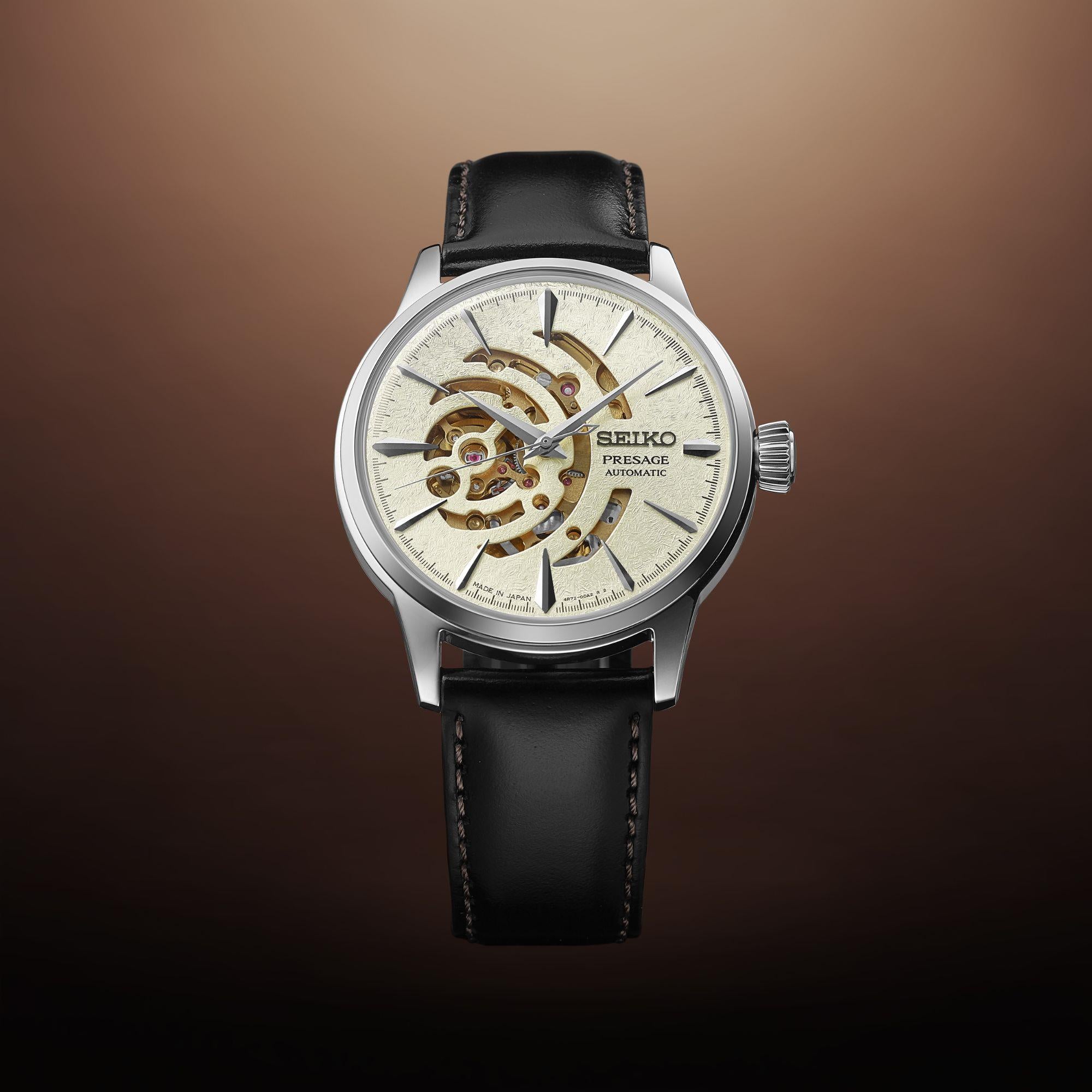 Seiko watch with black leather strap on a gradient brown background
