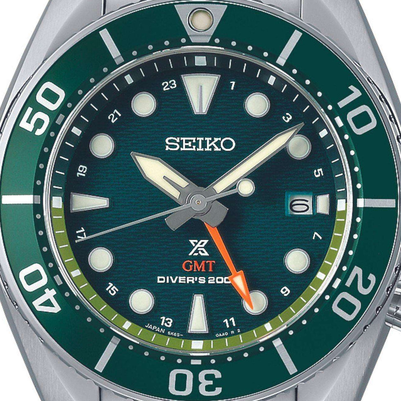 Close-up of Seiko Prospex Aqua Sumo GMT Watch SFK003J1 highlighting its green dial, matching bezel, and bright orange GMT hand.
