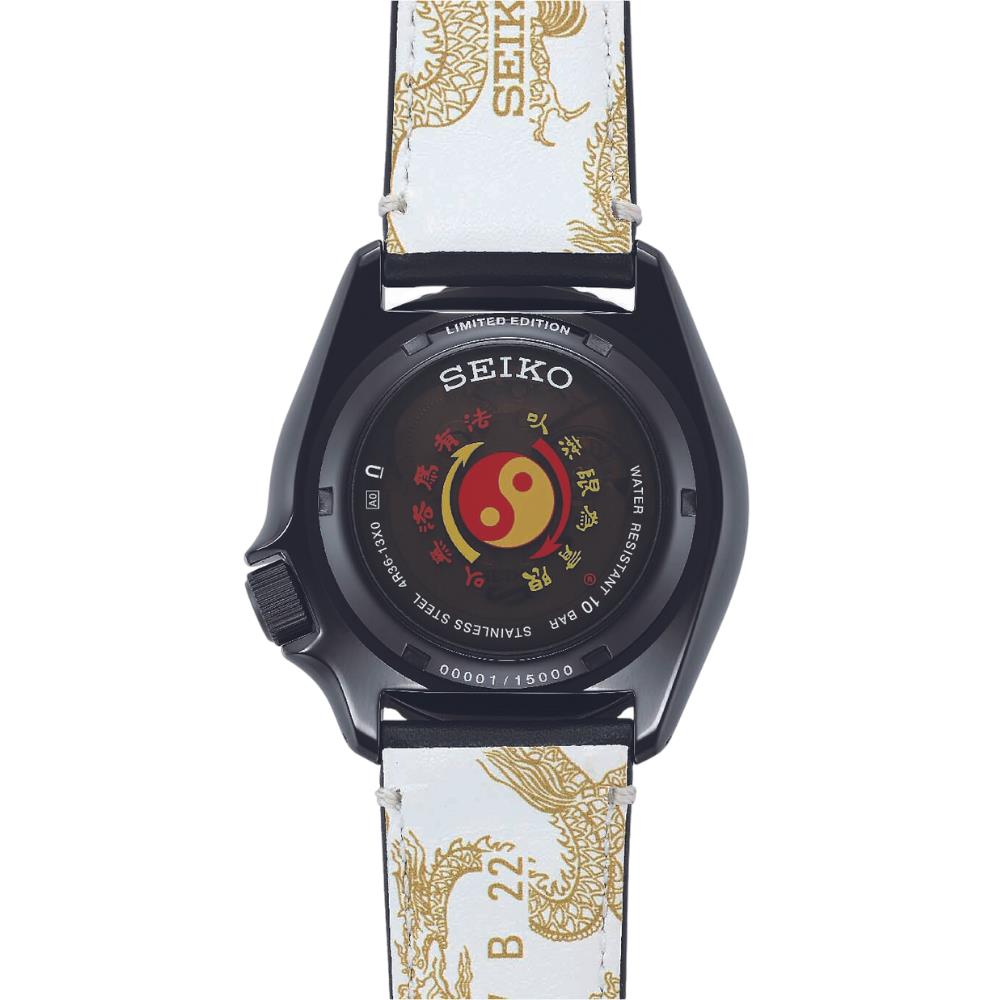 Seiko watch with a unique face and white strap with gold patterns on a white background