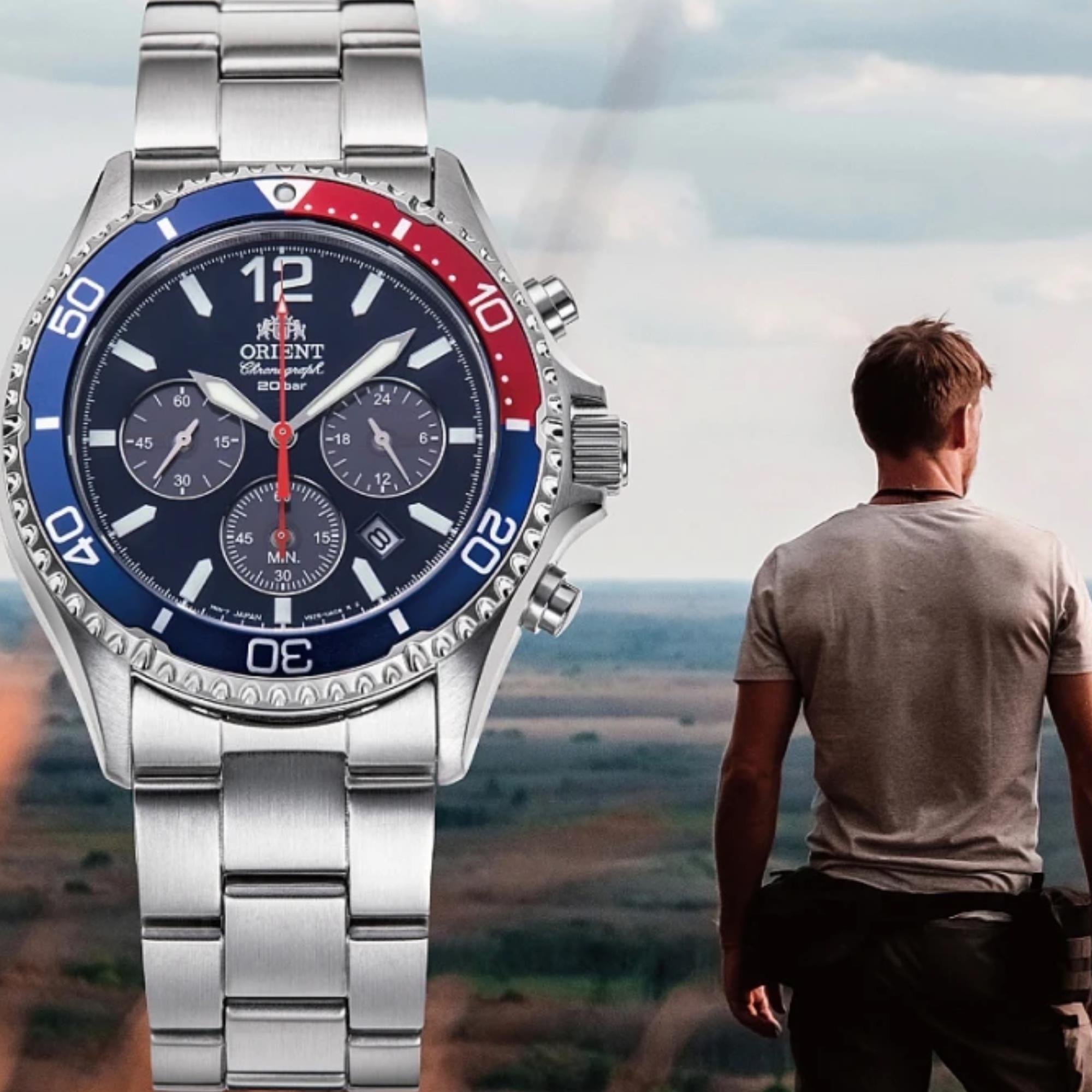 Orient Mako RA-TX0201L10B blue dial unidirectional bezel watch next to a man.