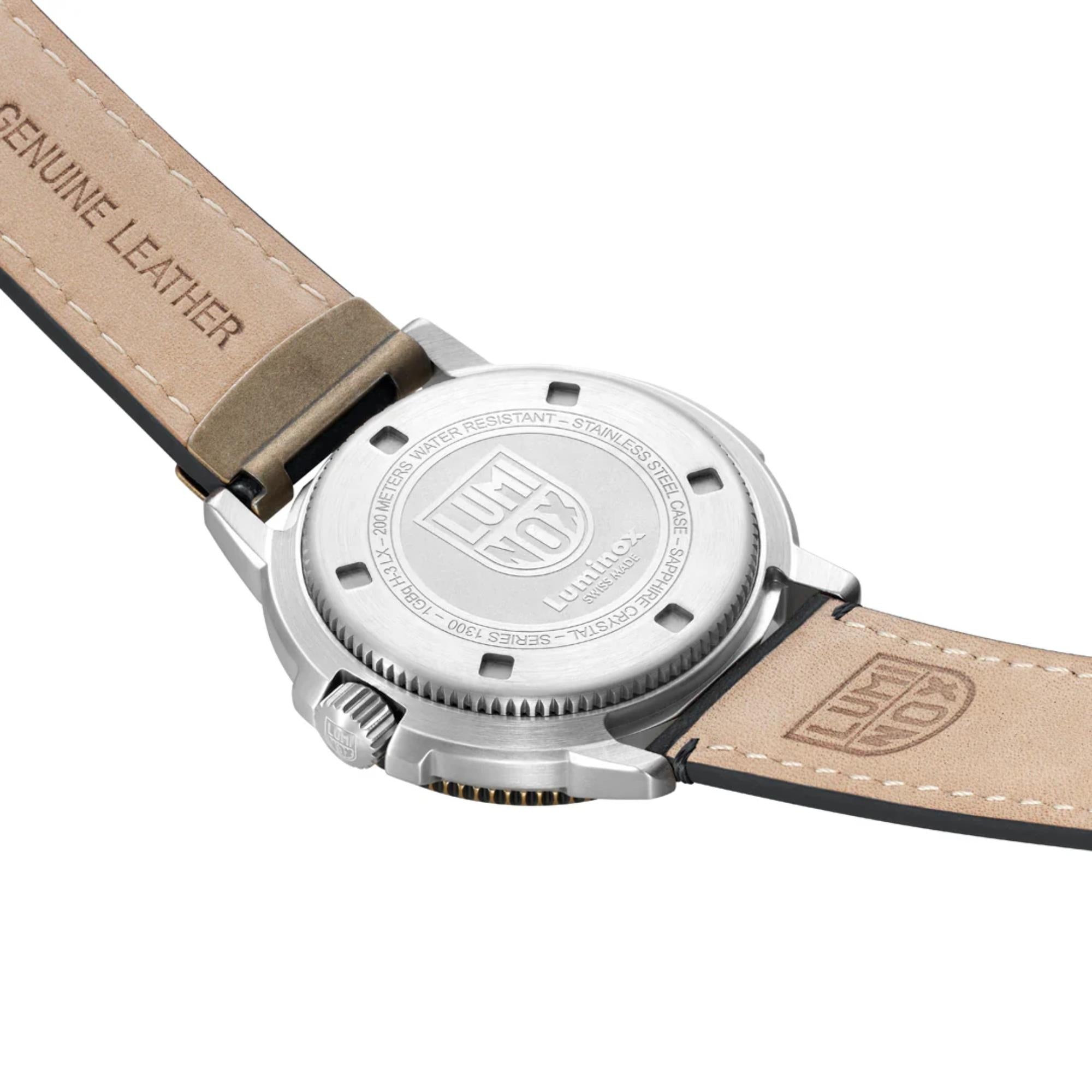 Angled view of engraved stainless steel caseback of the Luminox Adventure Watch XL.1301 and the light tan underside of its black leather strap