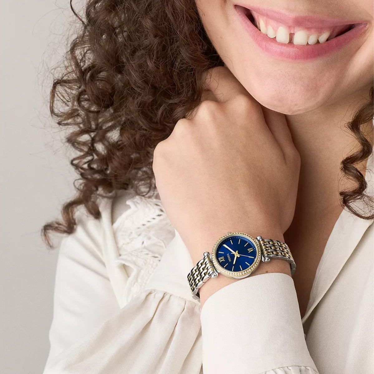 Ladies quartz watch on gold-and-silver metal bracelet with blue dial and gold hands