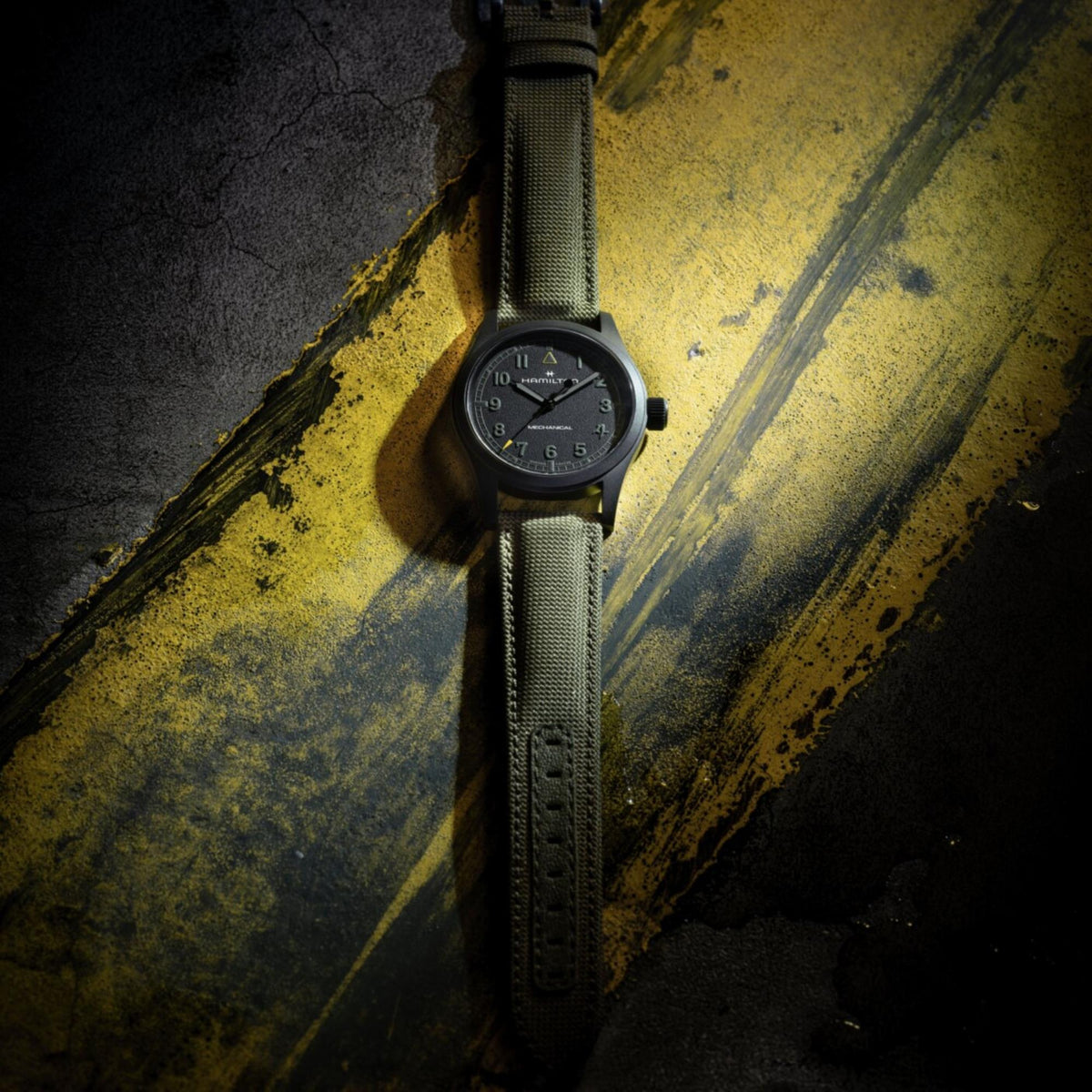 Hamilton Khaki Field Call of Duty H69469930 overhead view of black dial manual watch laid flat on textured surface
