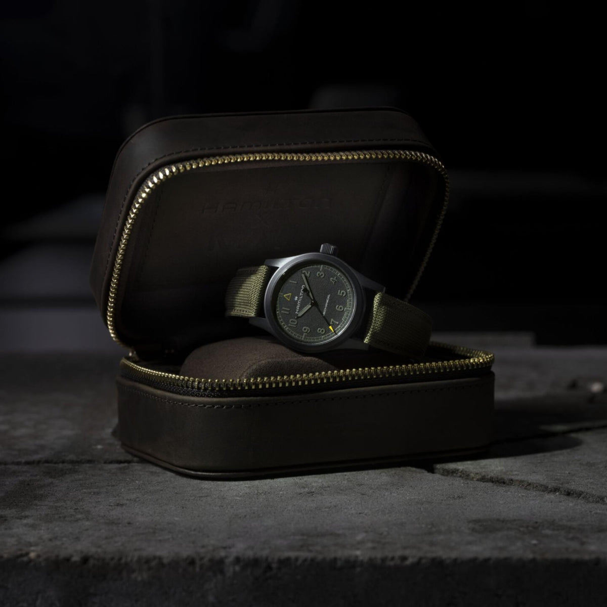 Hamilton Khaki Field Call of Duty H69469930 dramatic studio shot of black field watch resting in open travel case