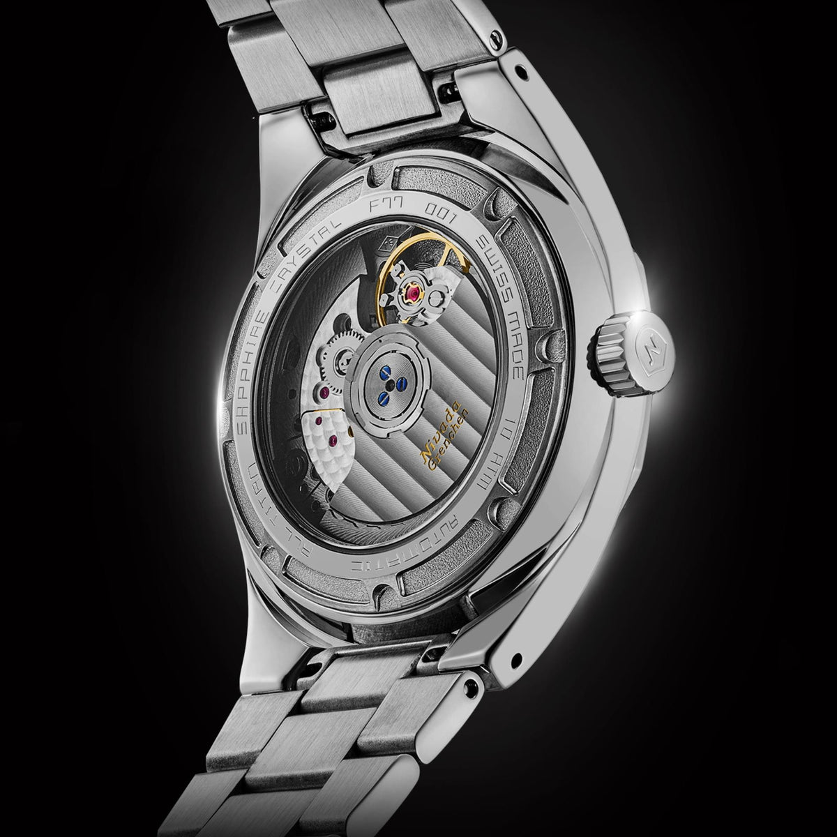 Nivada Grenchen F77 MK2 68052A77 close-up perspective of open case back detailing engraved text and automatic caliber assembly