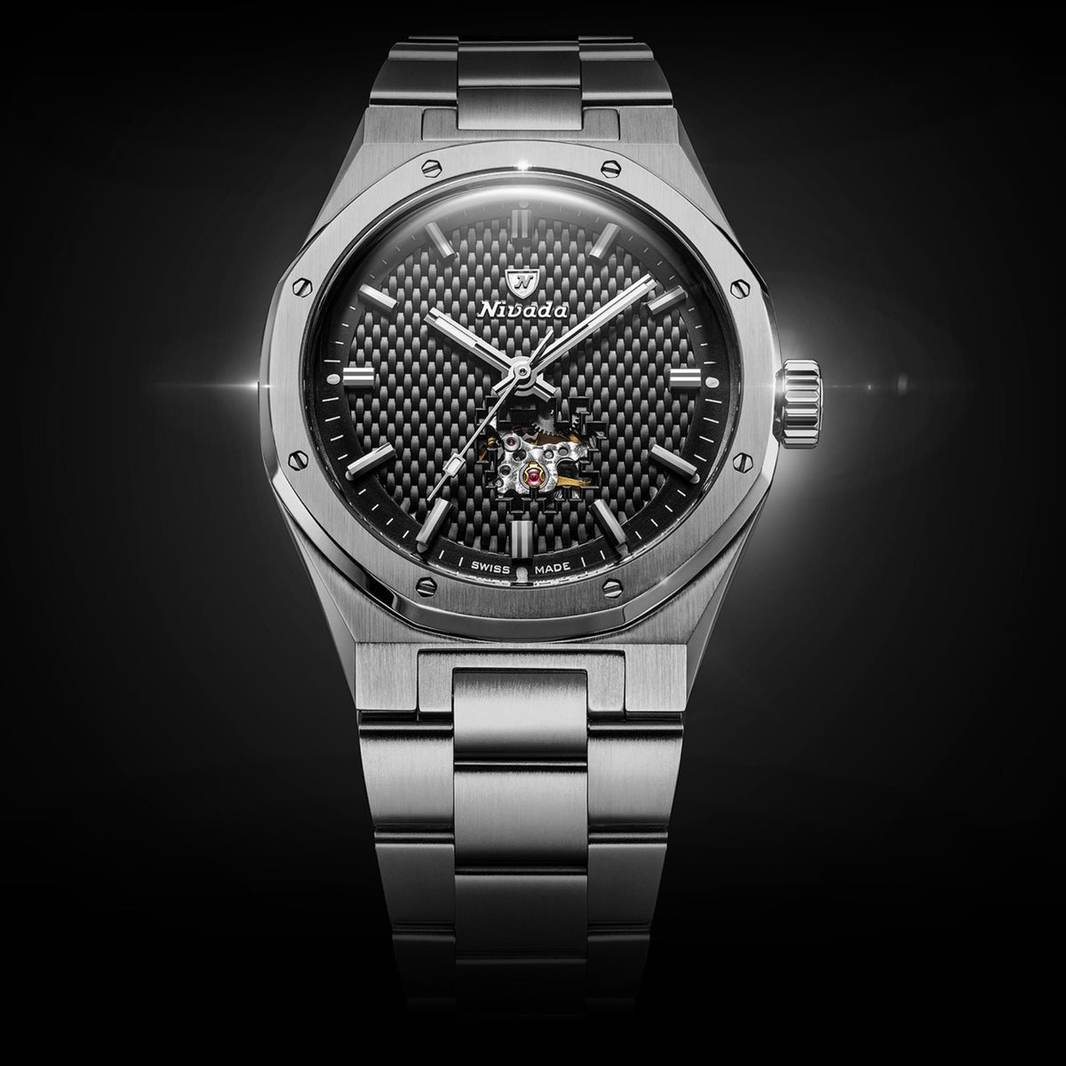 Nivada Grenchen F77 MK2 68023A77 straight face-on shot highlighting textured black embossed carbon pattern and open heart balance wheel