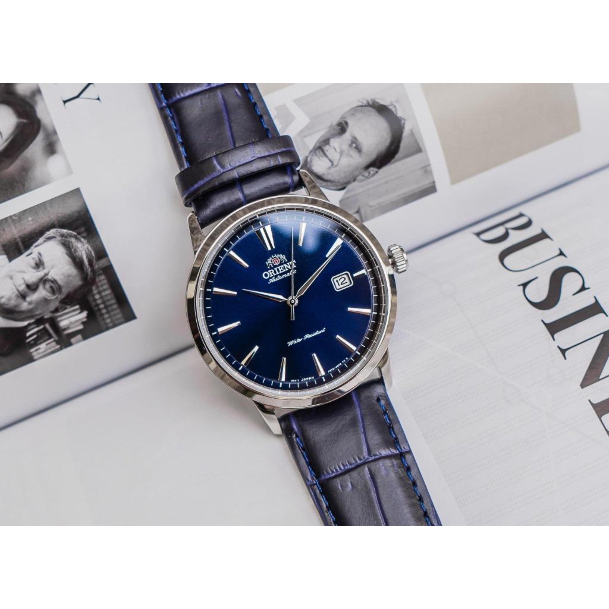 Orient Contemporary RA-AC0F06L30B automatic watch front view on book.
