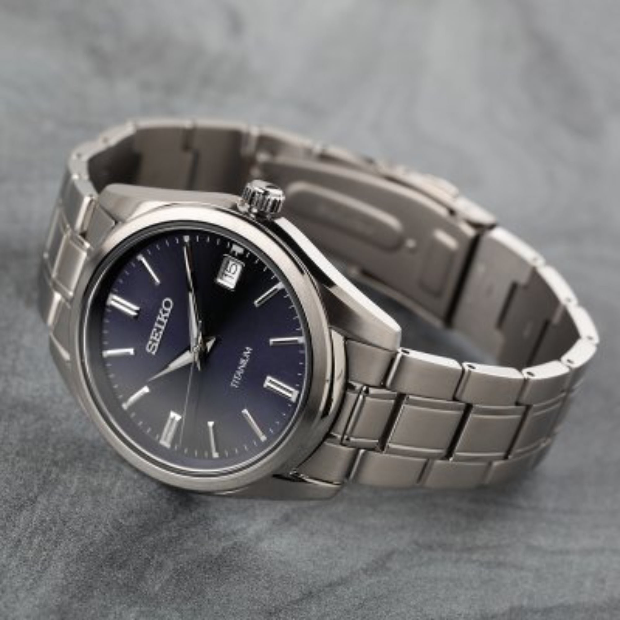 Angled view of Seiko SUR373P1 men's watch showing case side, crown and titanium bracelet