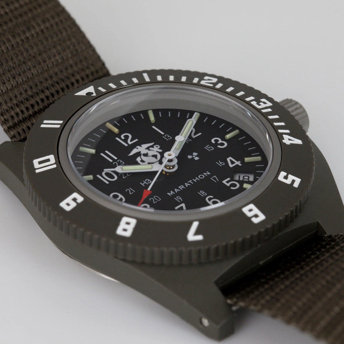 Marathon watch showing close angle of bidirectionally rotating bezel and khaki nylon strap