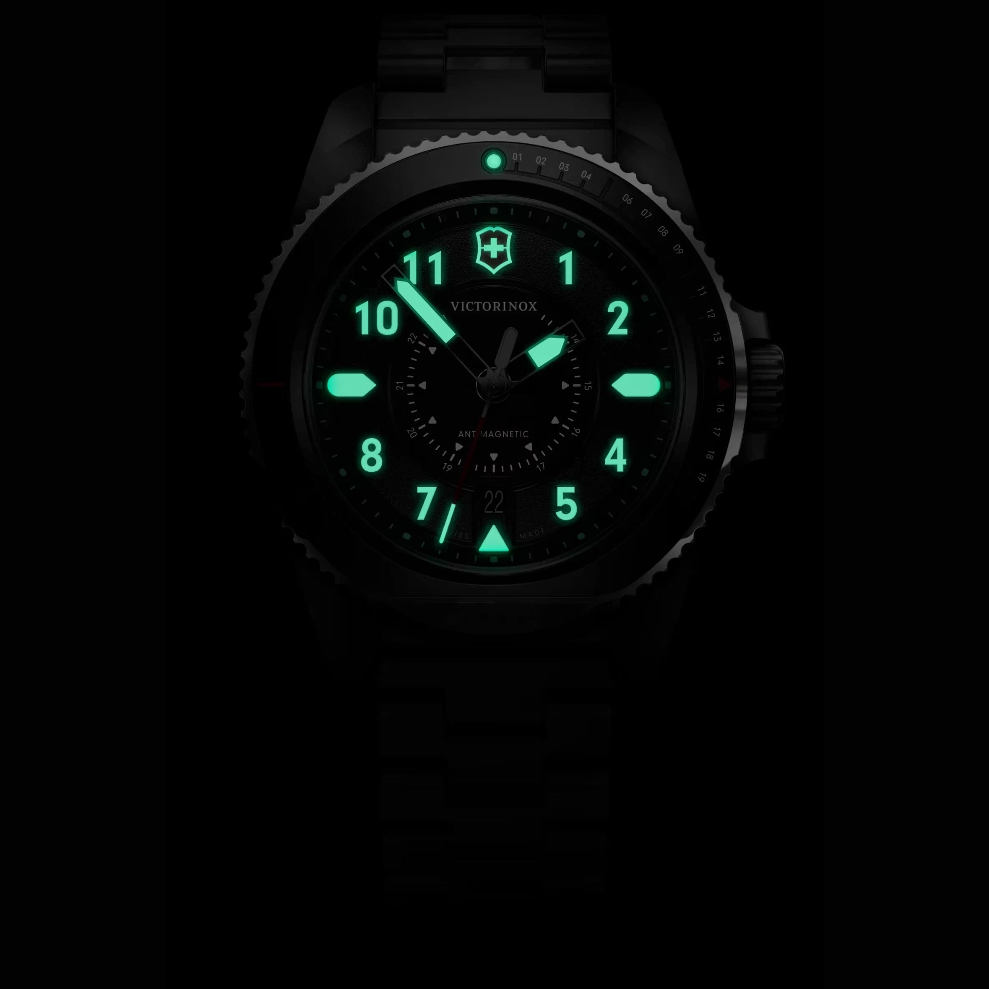 Victorinox Journey 1884 242009 stainless steel bracelet at night showing luminous hands and hour markers