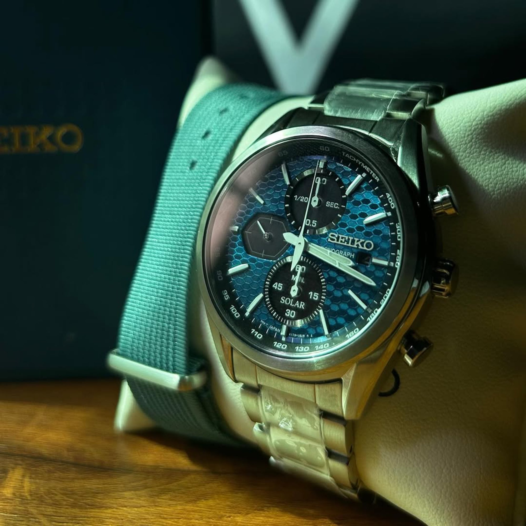 Seiko Essentials SSC801P1 Solar Chronograph watch with a Blue dial and steel bracelet on a display pillow