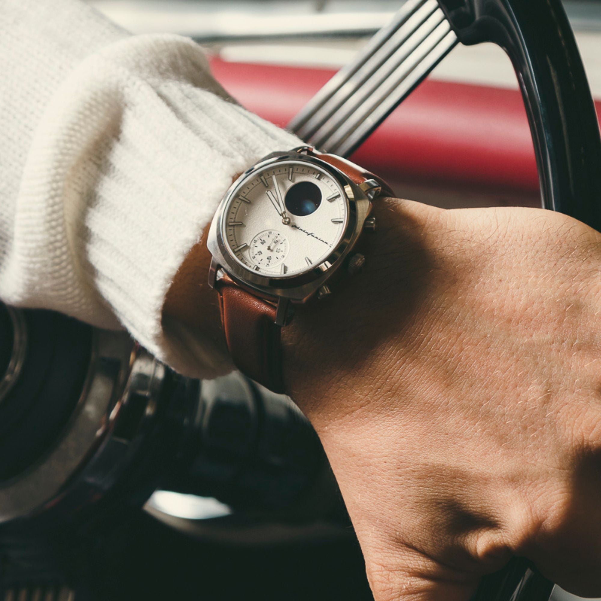 Pininfarina Senso Hybrid PMH01A-01 hybrid watch on wrist navigating a vintage steering wheel view