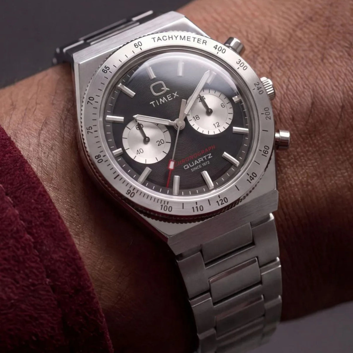 Timex Q Continental TW2Y93200 wrist view showing a black dial quartz watch styled on a person wearing a steel bracelet