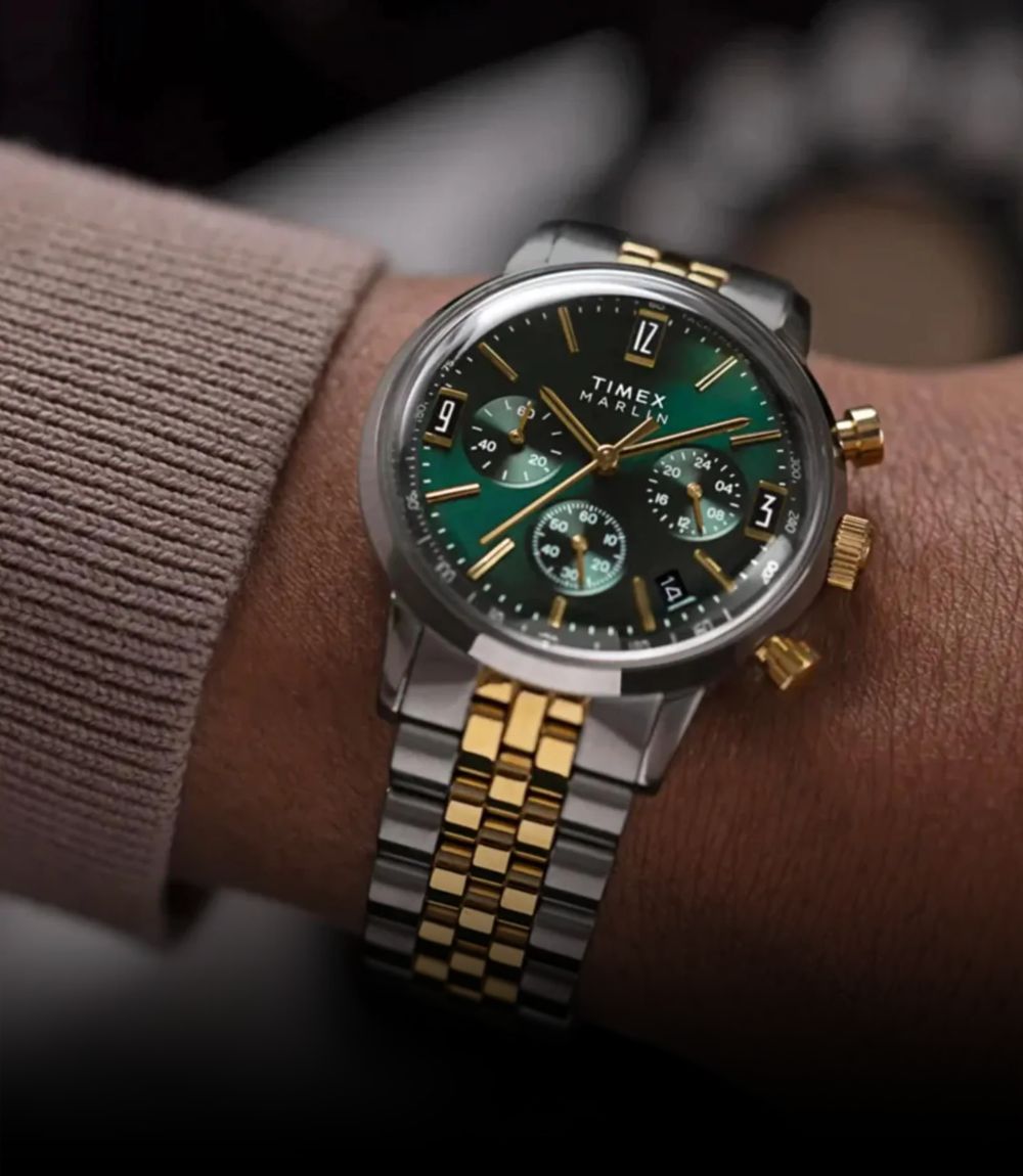 Timex Marlin chronograph watch with green sunray dial and two-tone stainless steel bracelet on wrist