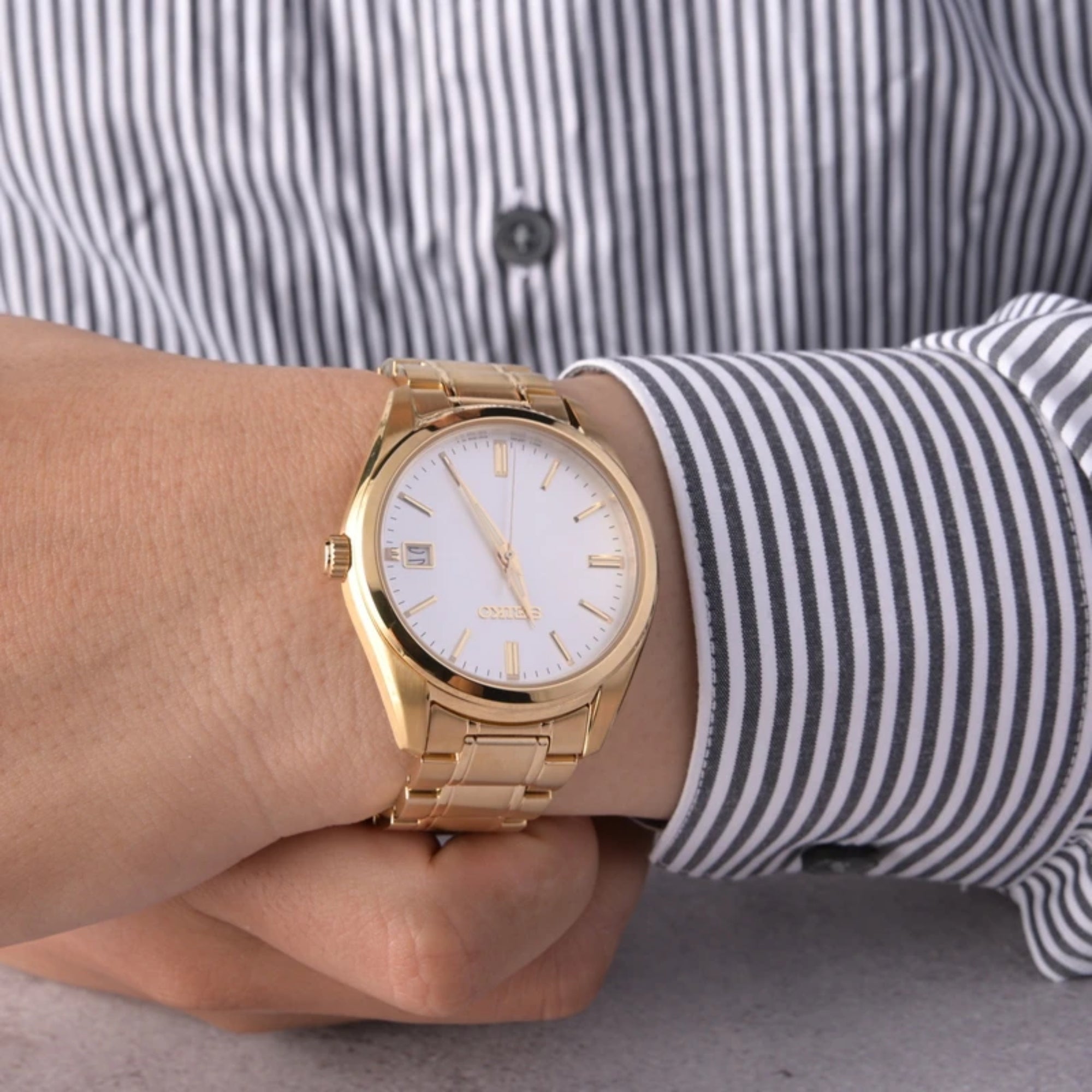 Seiko SUR314P1 gold-tone quartz dress watch on wrist
