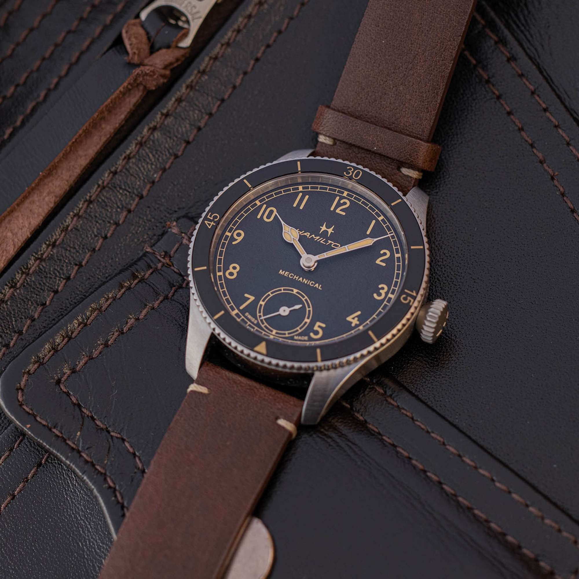 Hamilton Khaki Aviation H76205530 brown leather strap on dark background