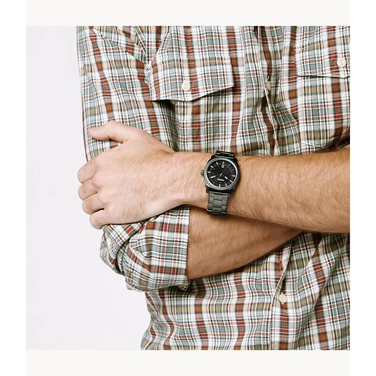 Person wearing a plaid shirt and watch on a white background