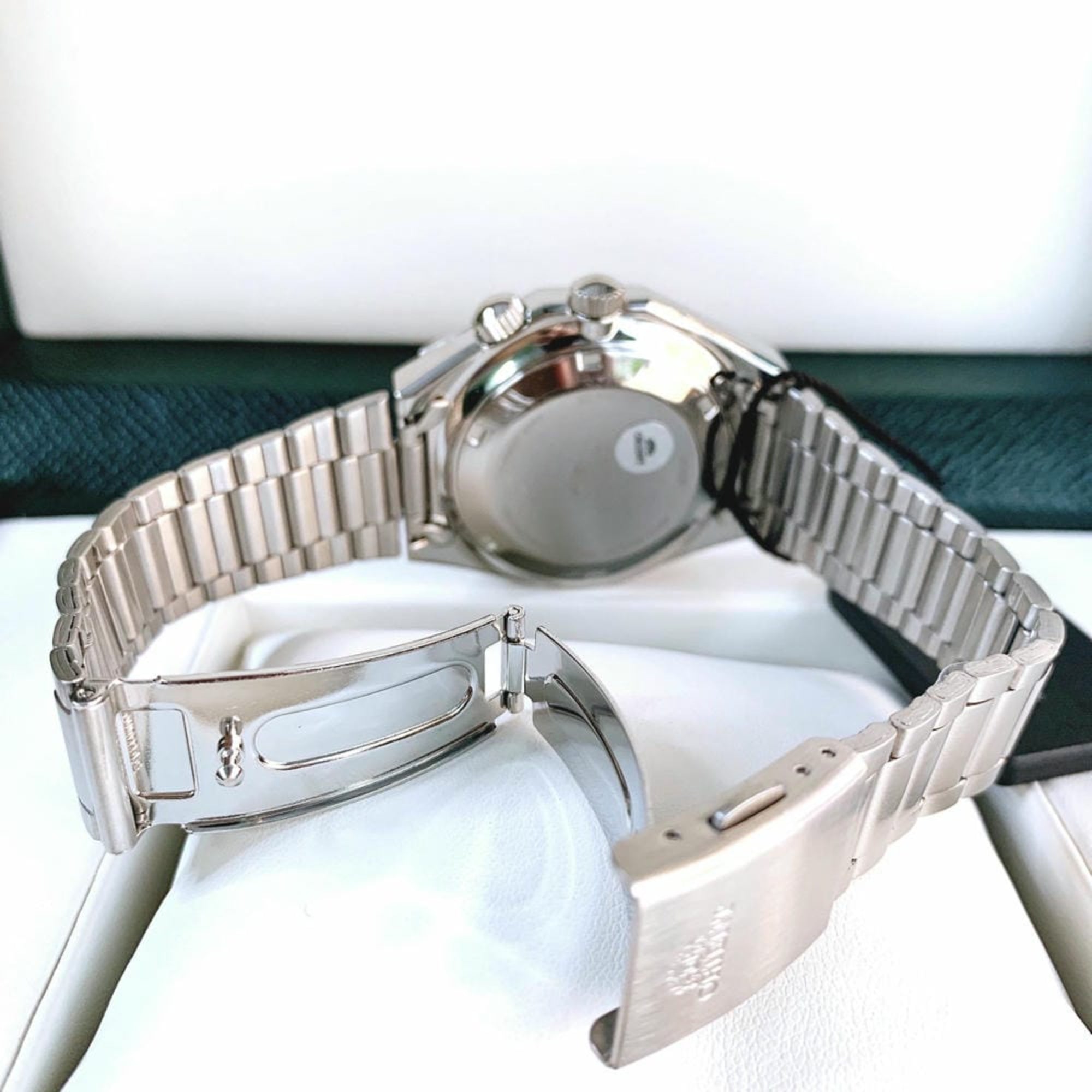Rear view of an Orient Neo 70s watch showing deployment clasp and steel bracelet.