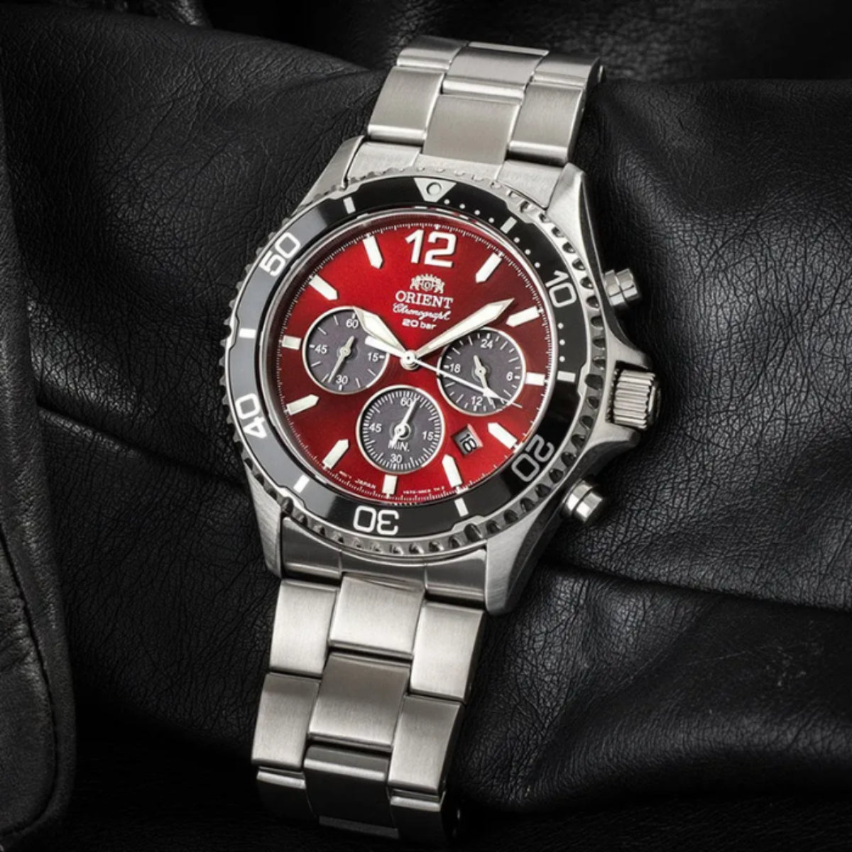Orient RA-TX0207R10B 43mm red dial chronograph watch on black leather surface