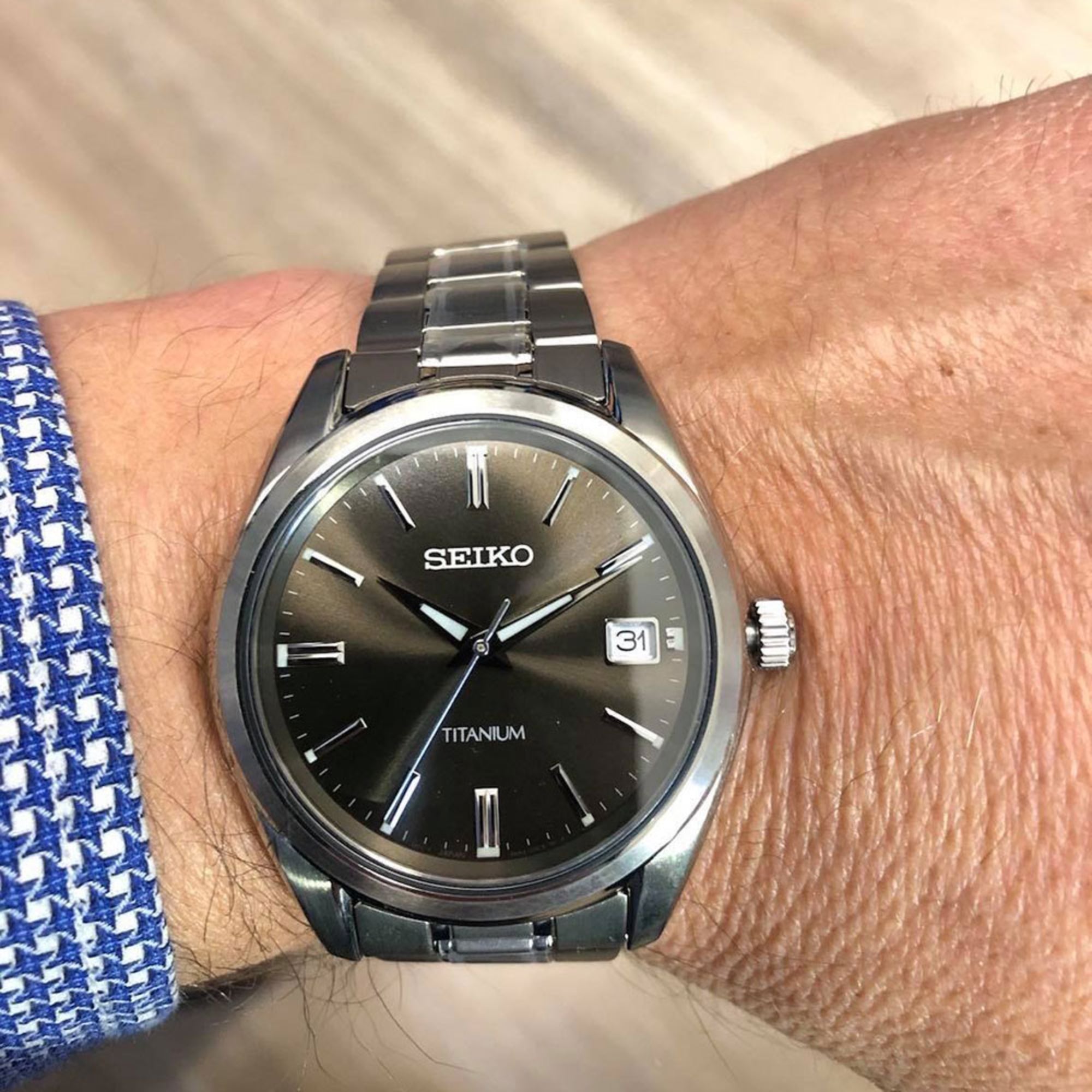 Seiko Essentials watch on a wrist with titanium bracelet