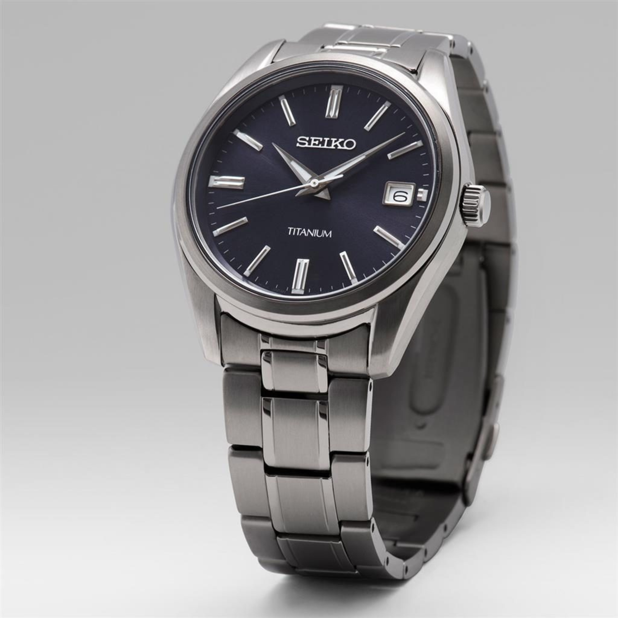 Seiko Essentials SUR373P1 40mm blue dial titanium men's quartz watch full front view on light background