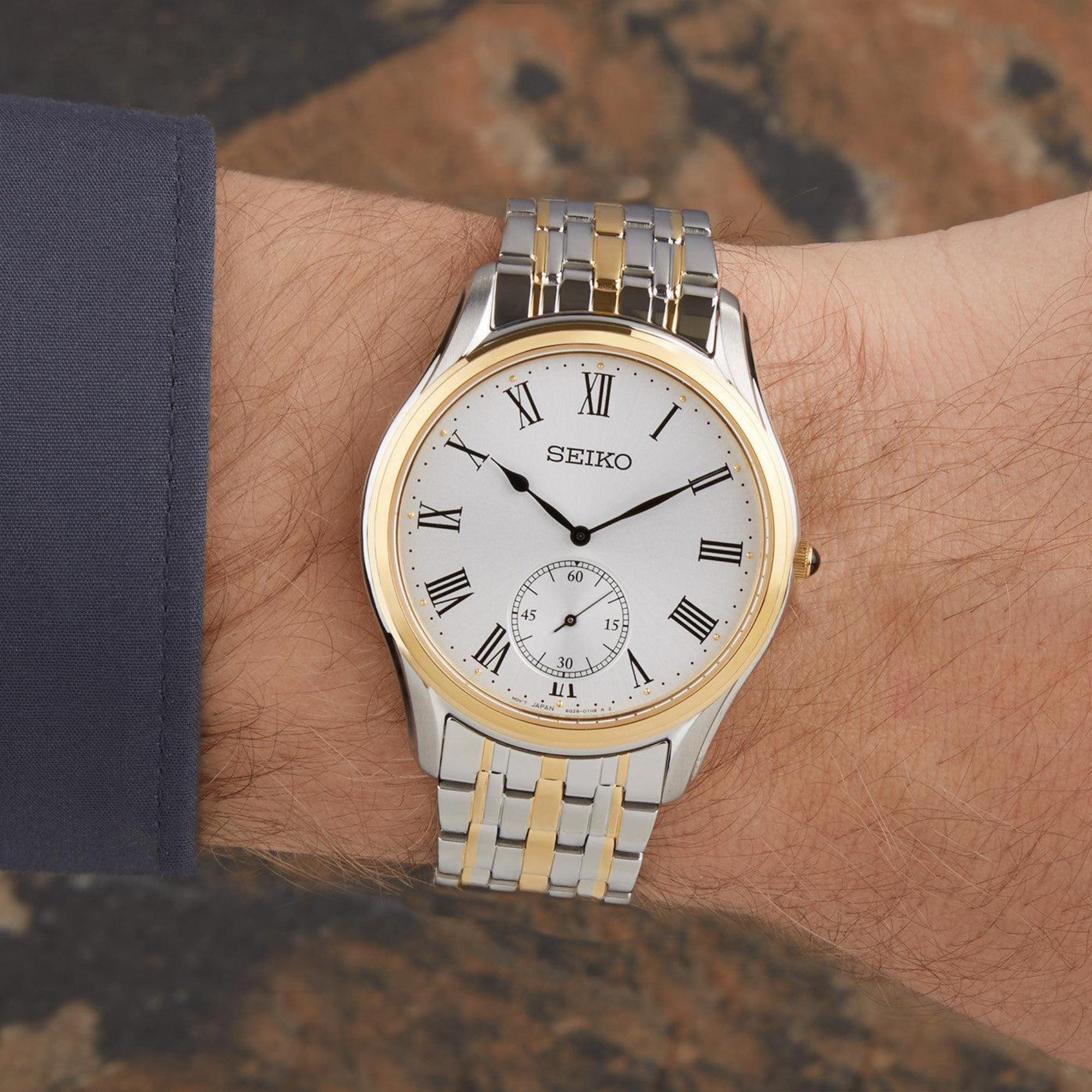 Seiko Essentials 39mm white dial two-tone slim dress watch on wrist
