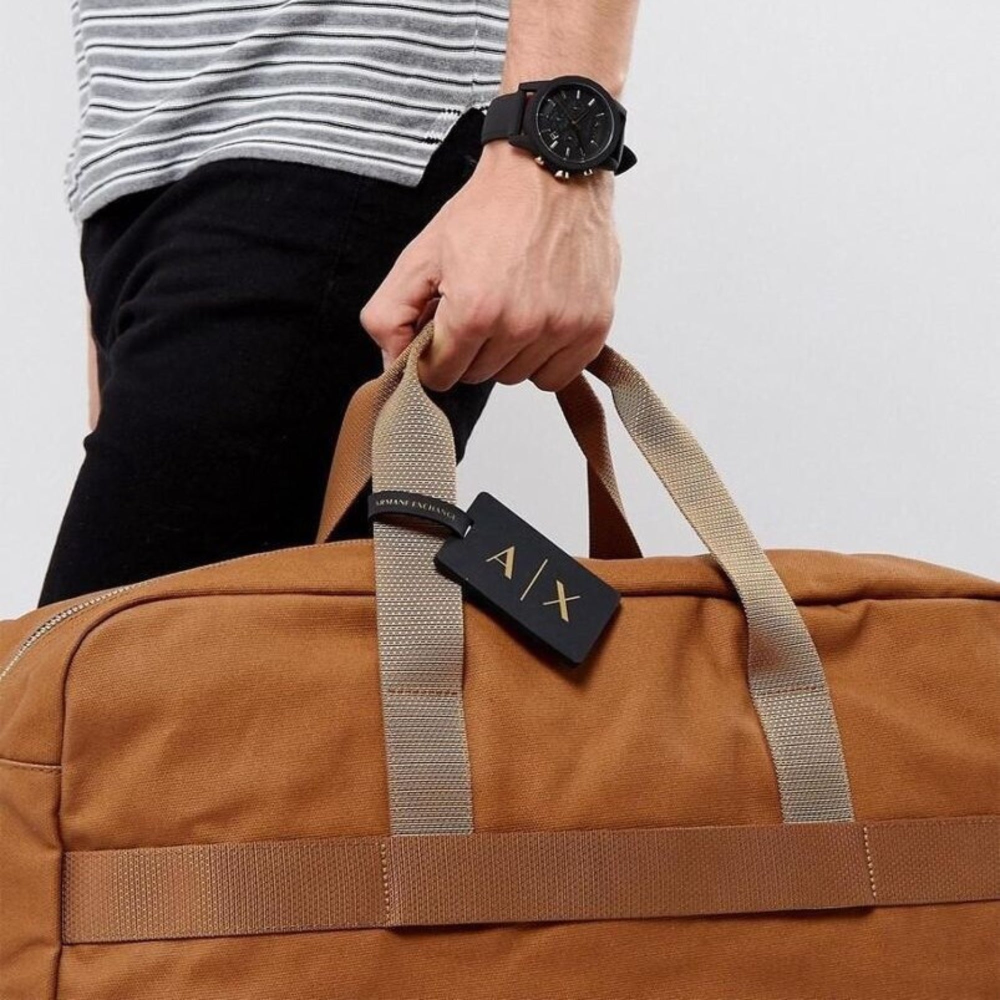 Armani Exchange Outerbanks AX7105 black chronograph watch paired with travel bag for a modern everyday style.