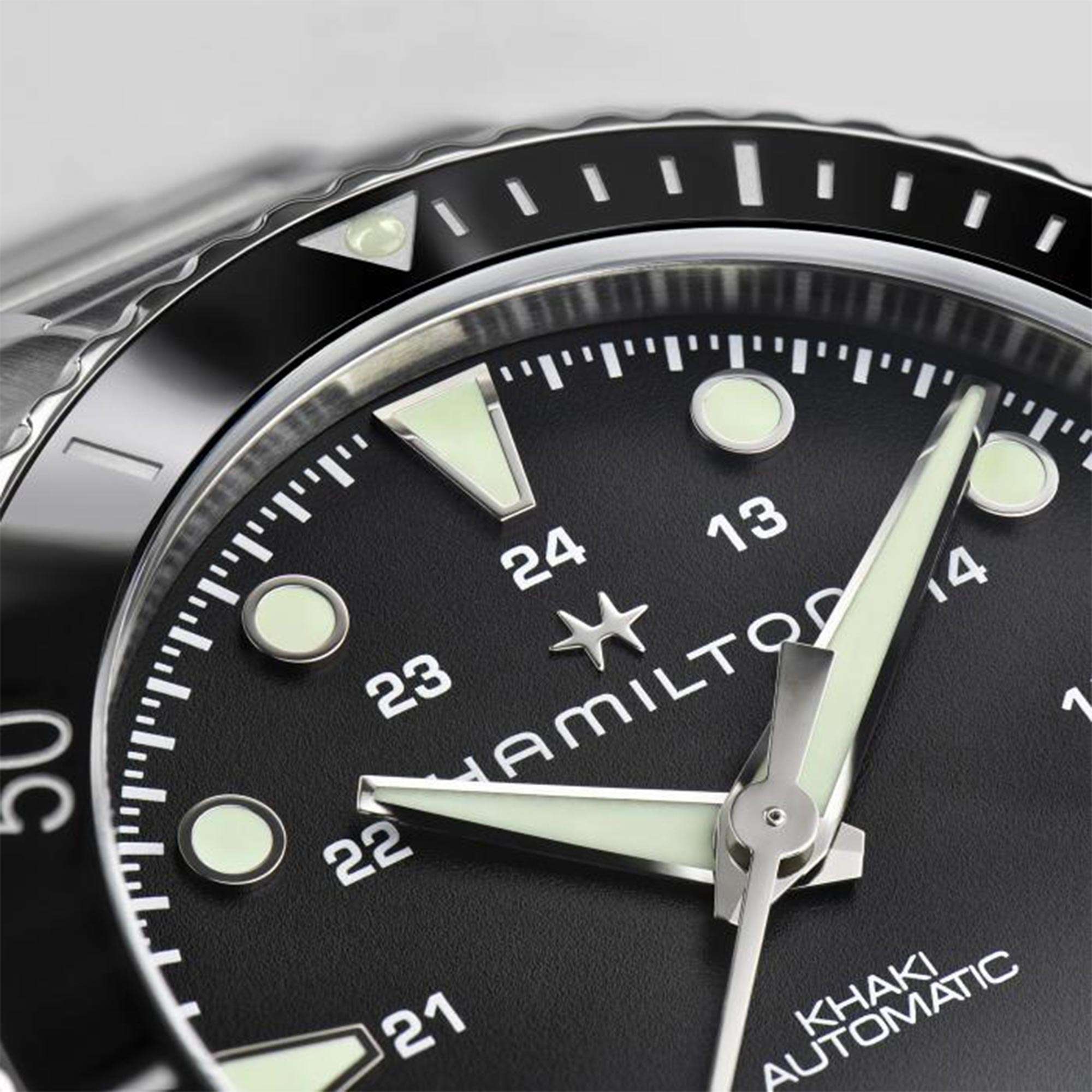 Hamilton H82515130 black dial with red-tipped seconds hand and ceramic bezel close-up