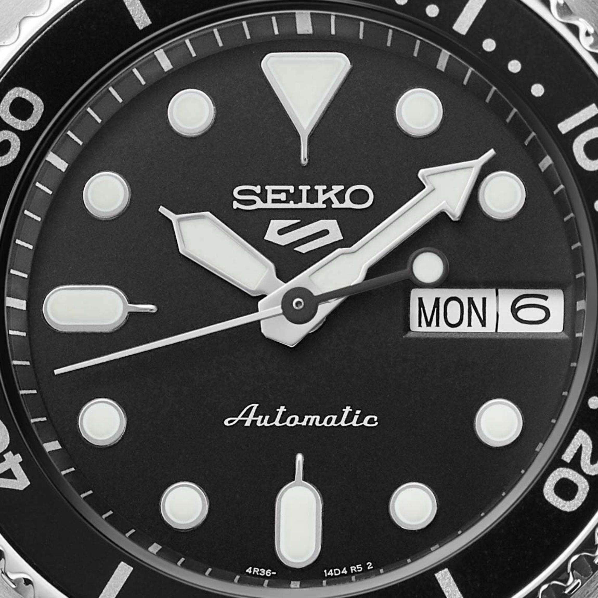 Seiko watch face with black dial and white markings