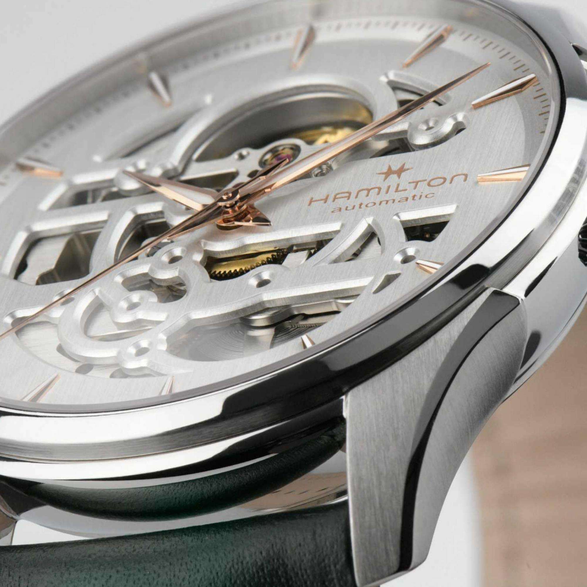Close-up of a Hamilton Jazzmaster Skeleton watch with a white dial and rose gold hands