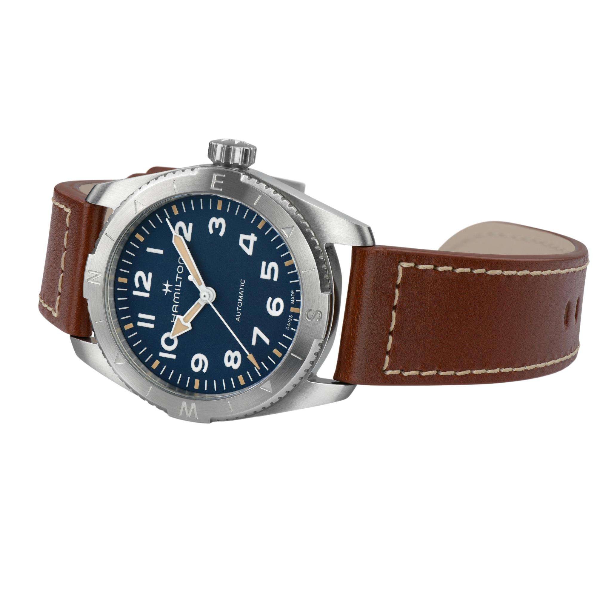 Hamilton Khaki Field Expedition automatic watch with a blue dial, compass bezel, and brown leather strap