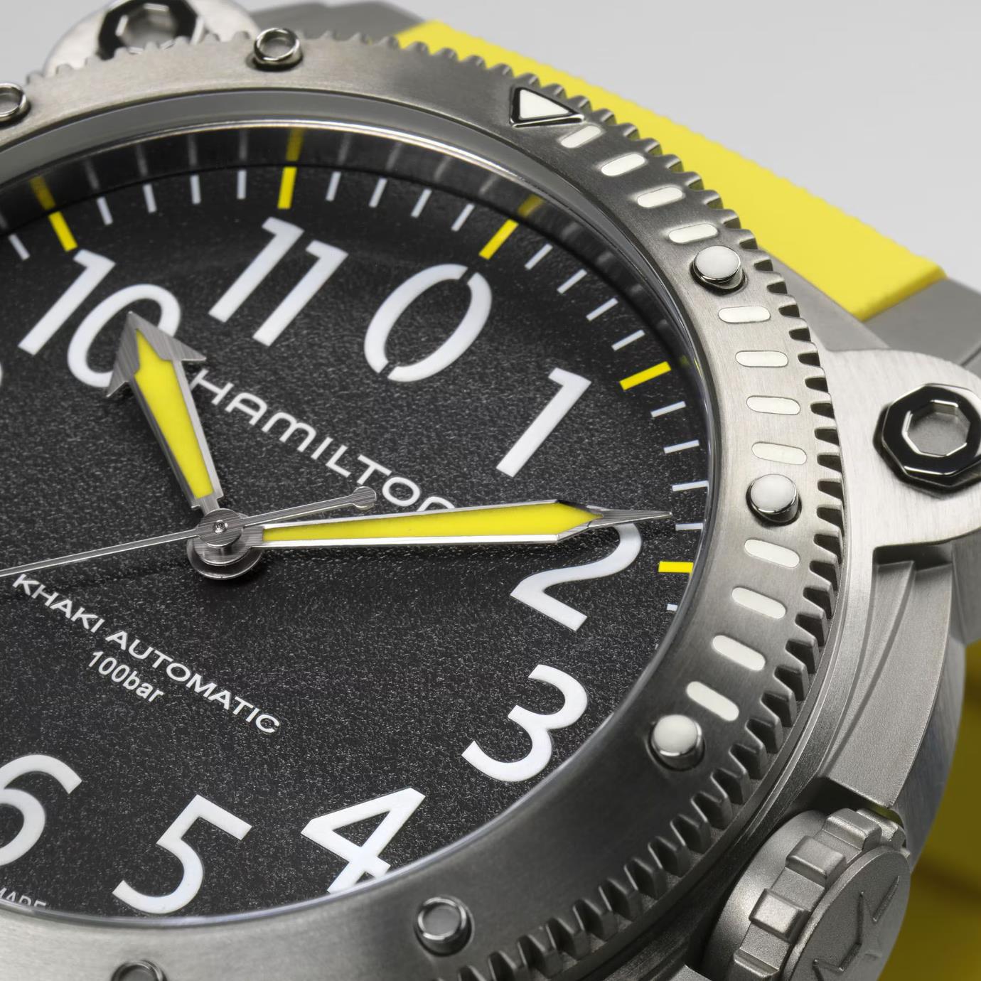 Close-up of a Hamilton Khaki Automatic watch dial with a yellow hands