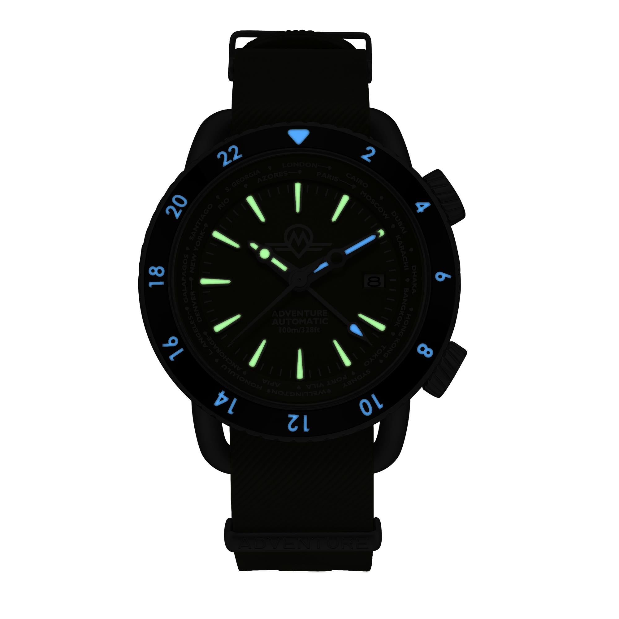 Monro Adventure MA-4 dial and 24-hour bezel blue and green luminous display in the dark close-up
