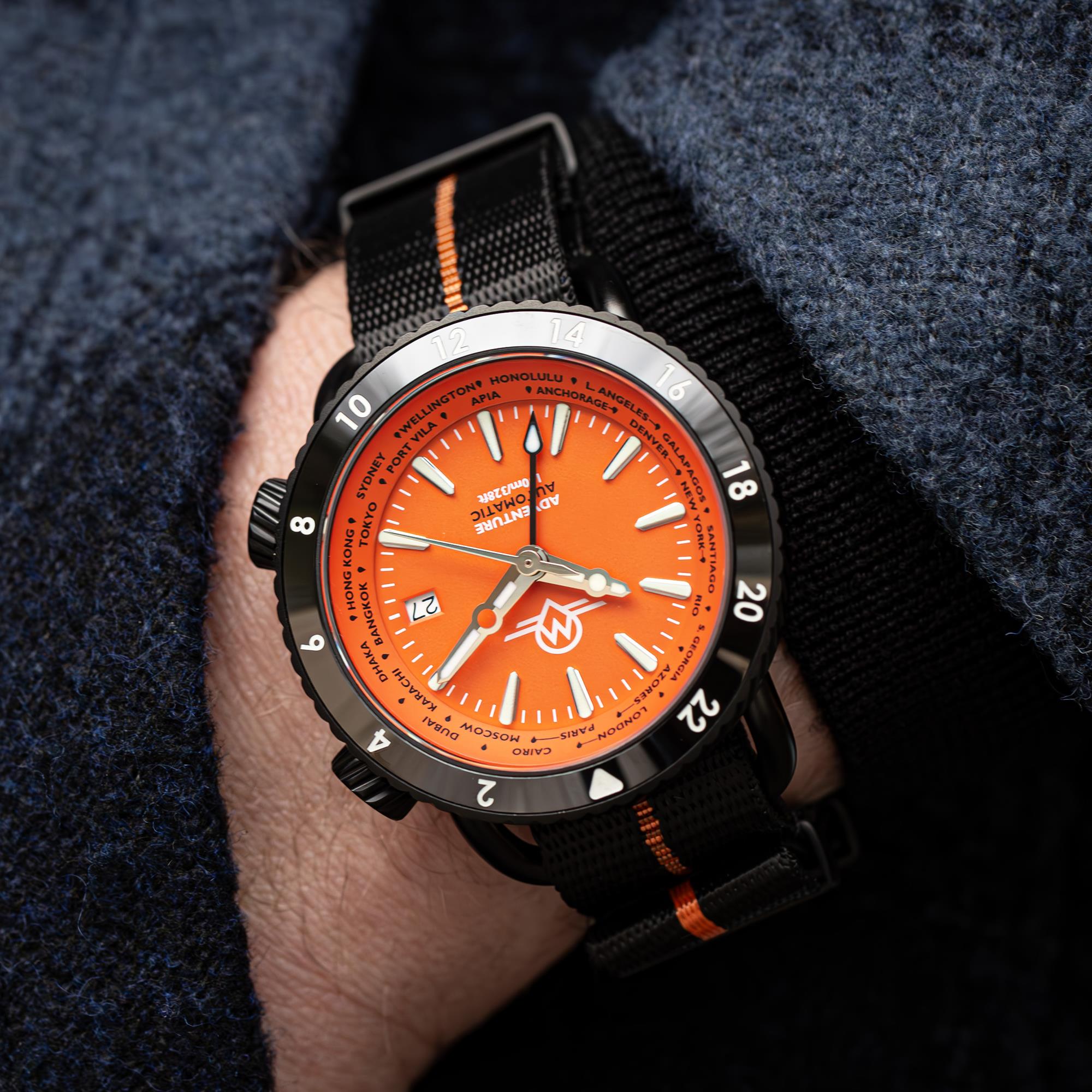 Monro Adventure Automatic Night Fire MA-7 watch with black and orange nylon strap on a wrist view