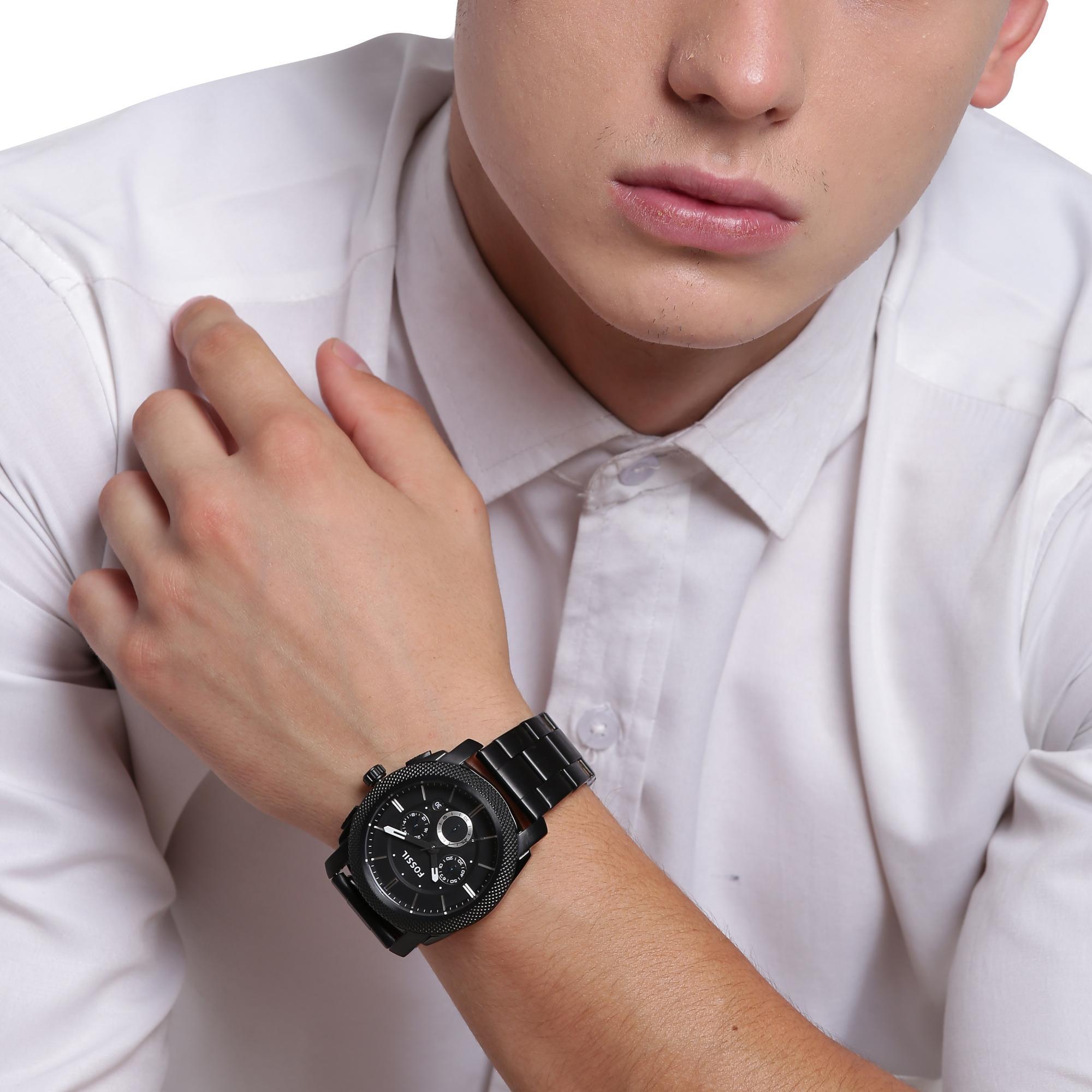 Person wearing a black wristwatch on a white background