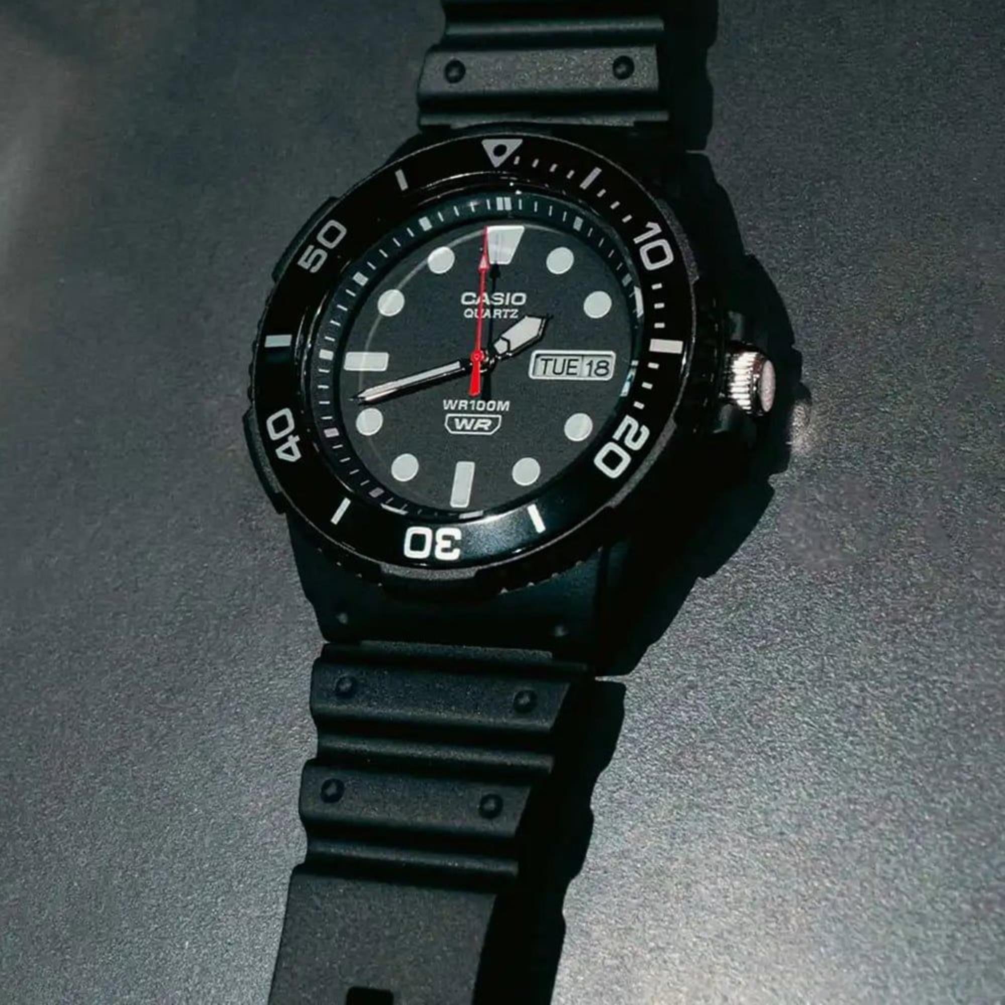 Black Casio watch on a dark background