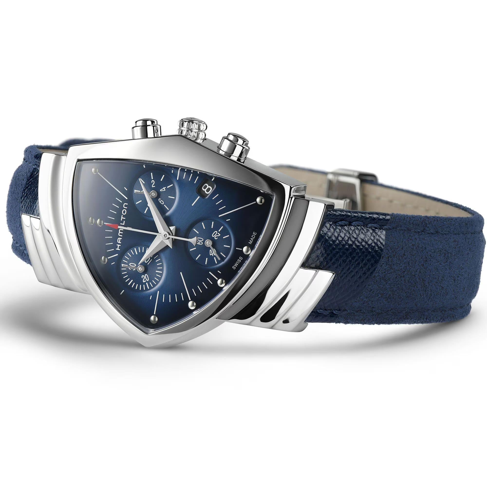 Angled close-up of a Hamilton Ventura Chronograph watch, stainless steel case, blue dial, and textured blue strap