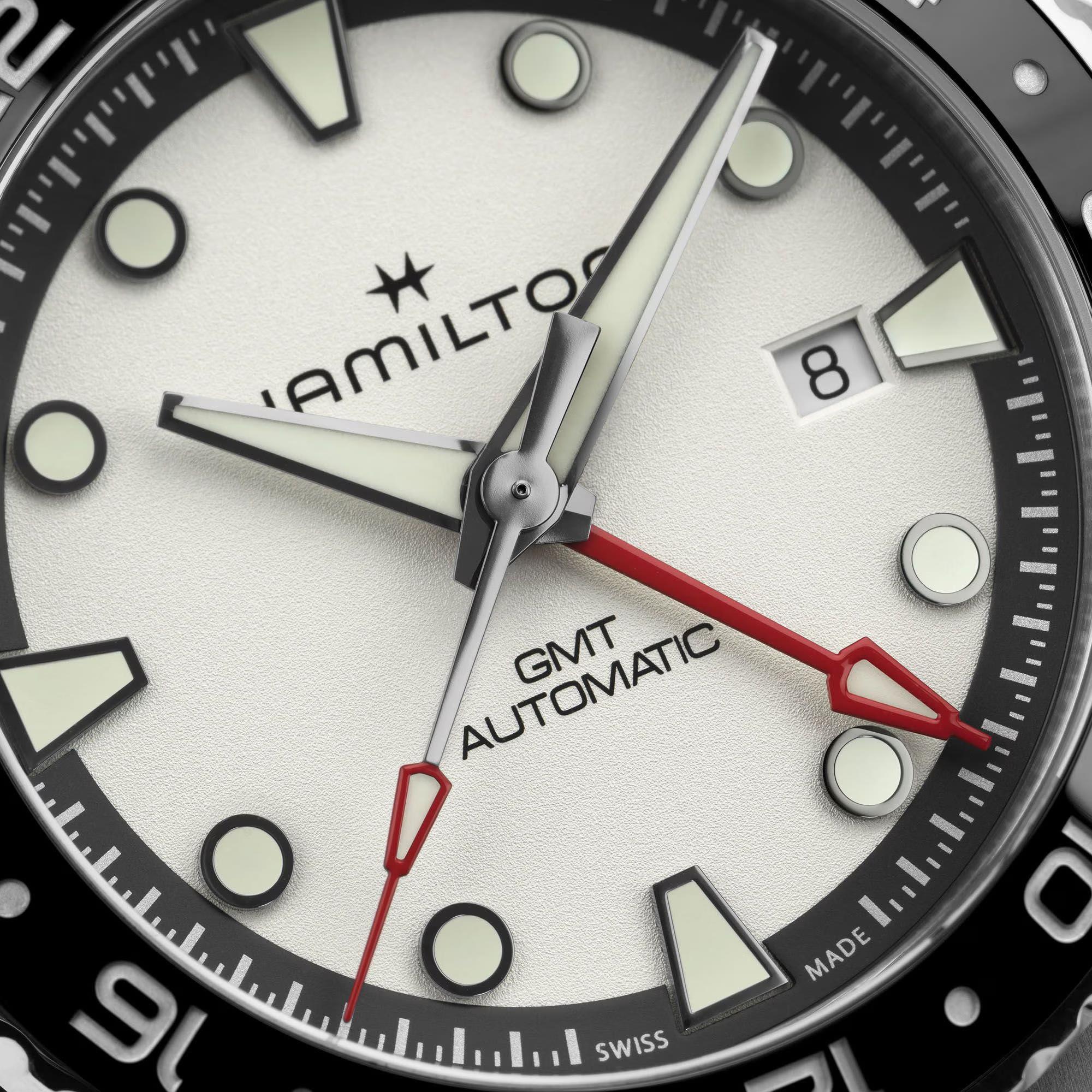 Hamilton Khaki Navy H82555150 silver dial with red GMT hand and luminous markers close-up